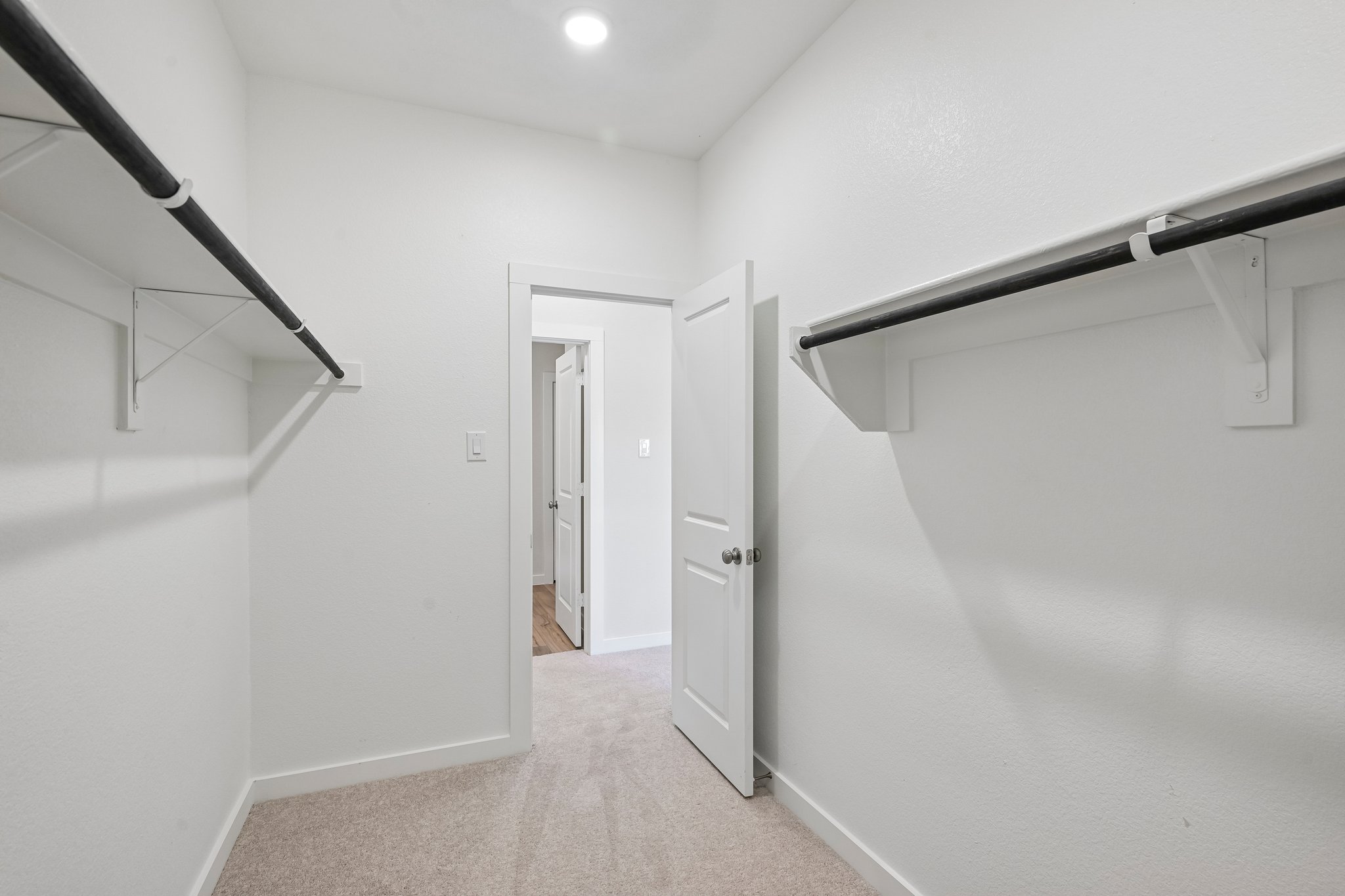 A hallway with white walls.