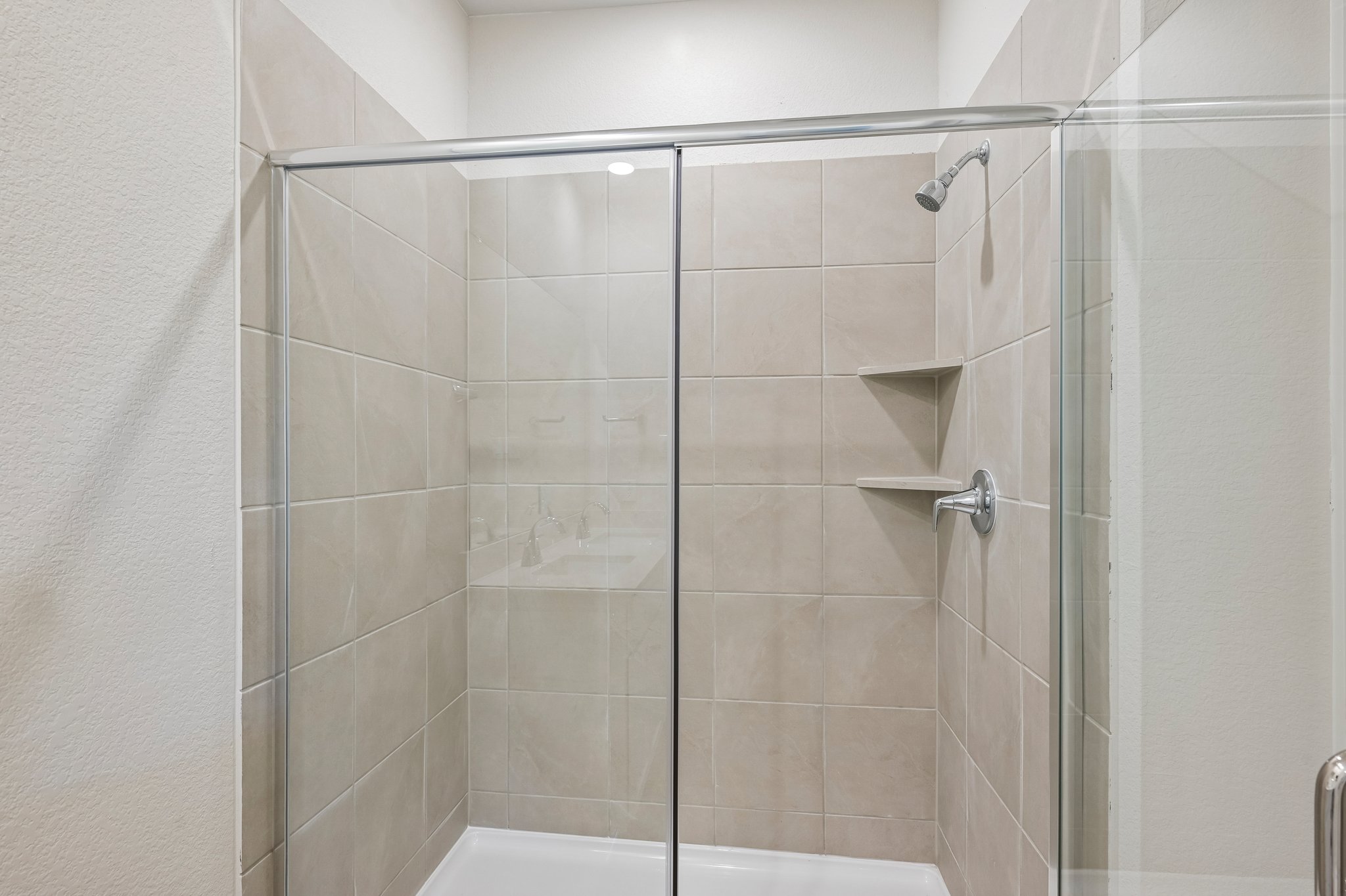 A shower with a glass door.