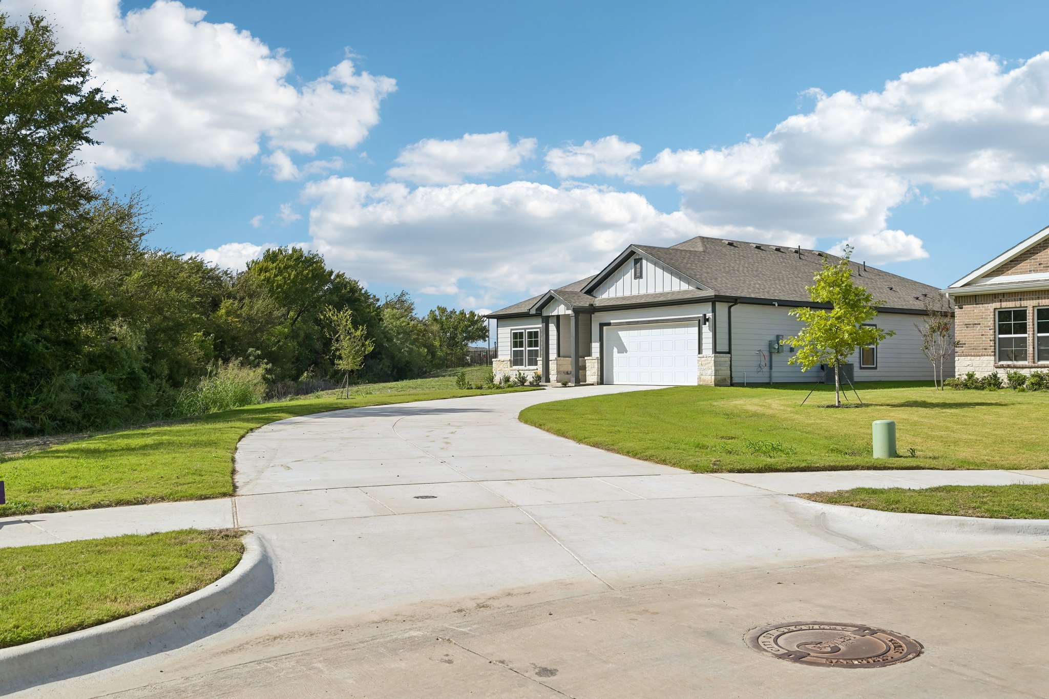 A driveway leading to a house.