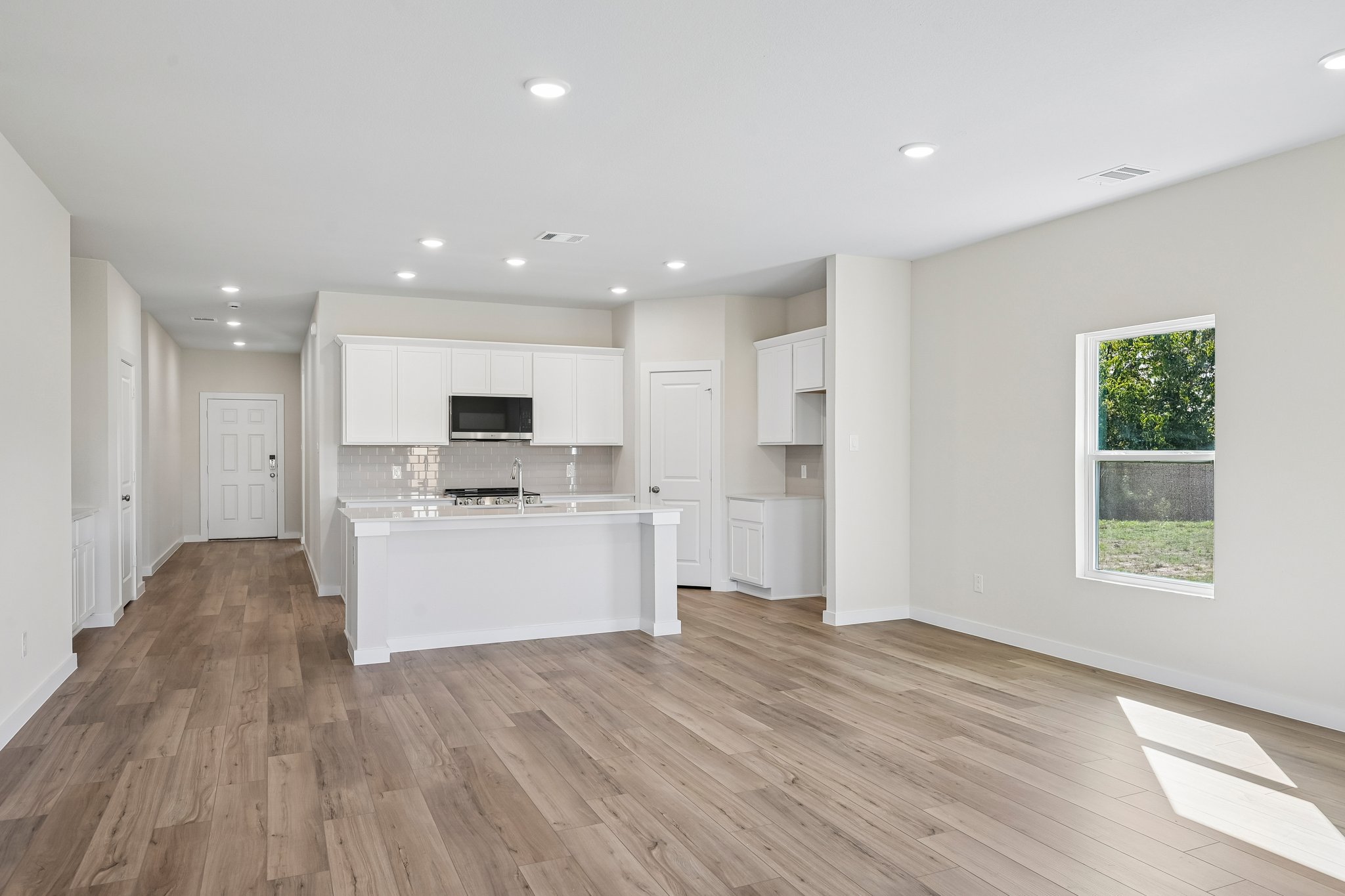A kitchen with white cabinets.