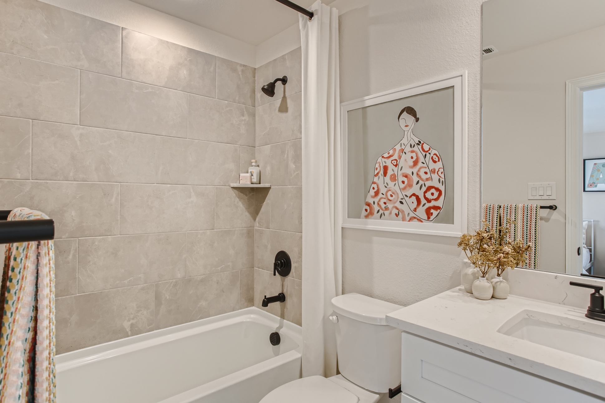 A bathroom with a tub toilet and sink.