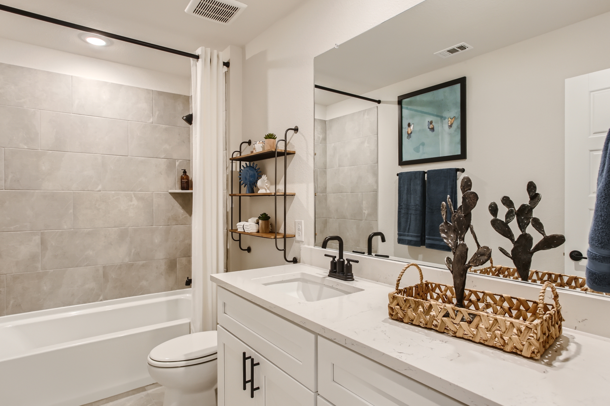 A bathroom with a large mirror.