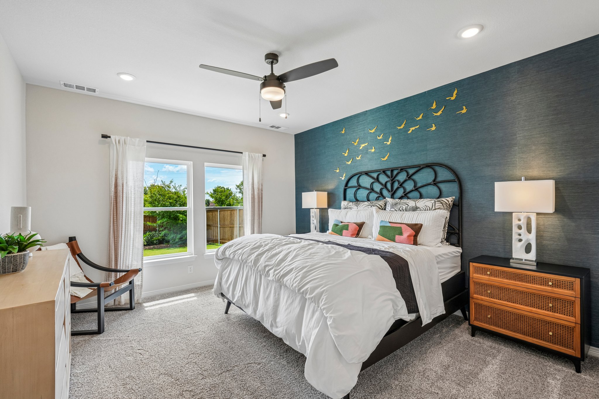 A bedroom with a bed and a fan.