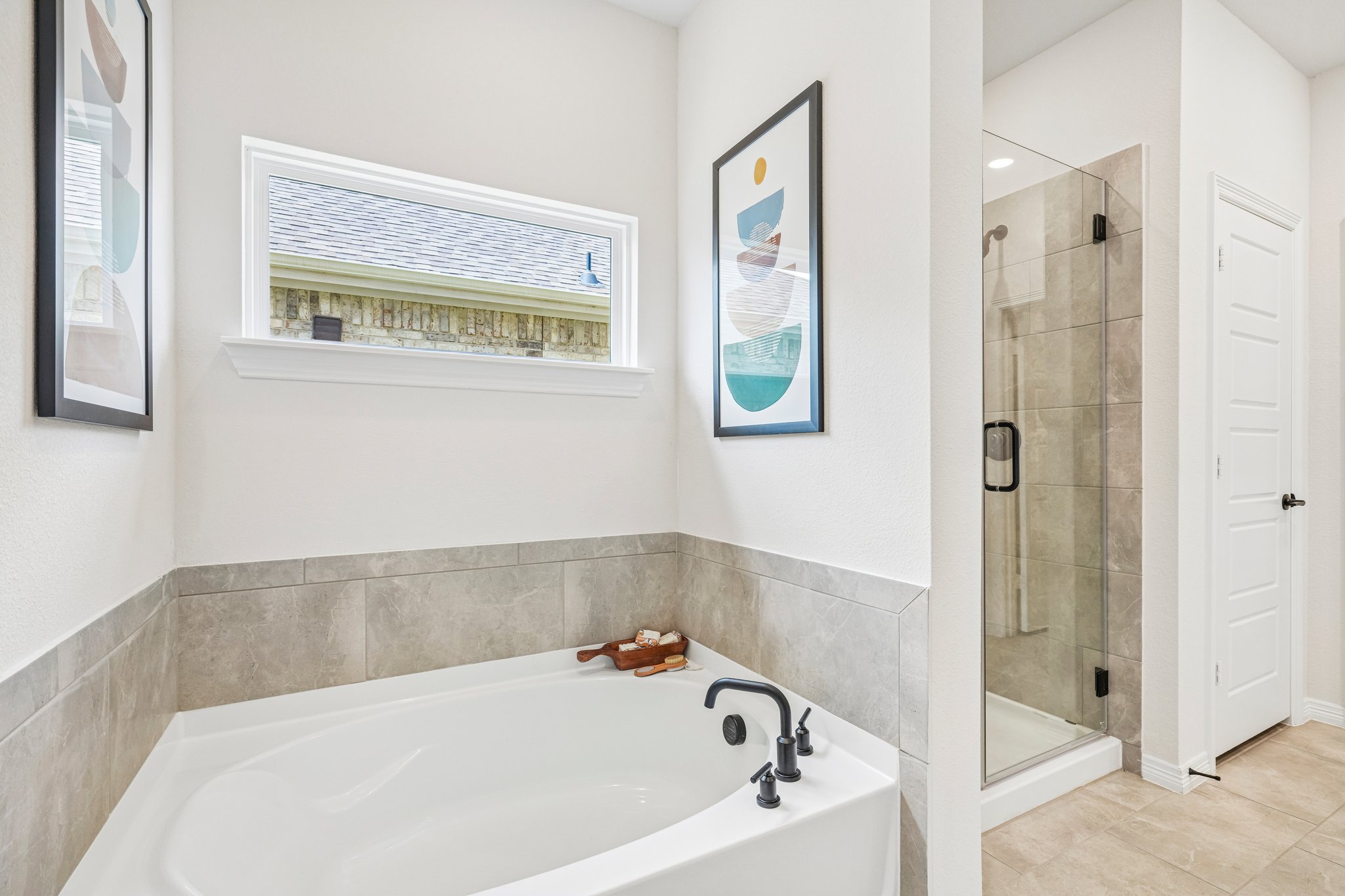 A bathroom with a tub and a shower.
