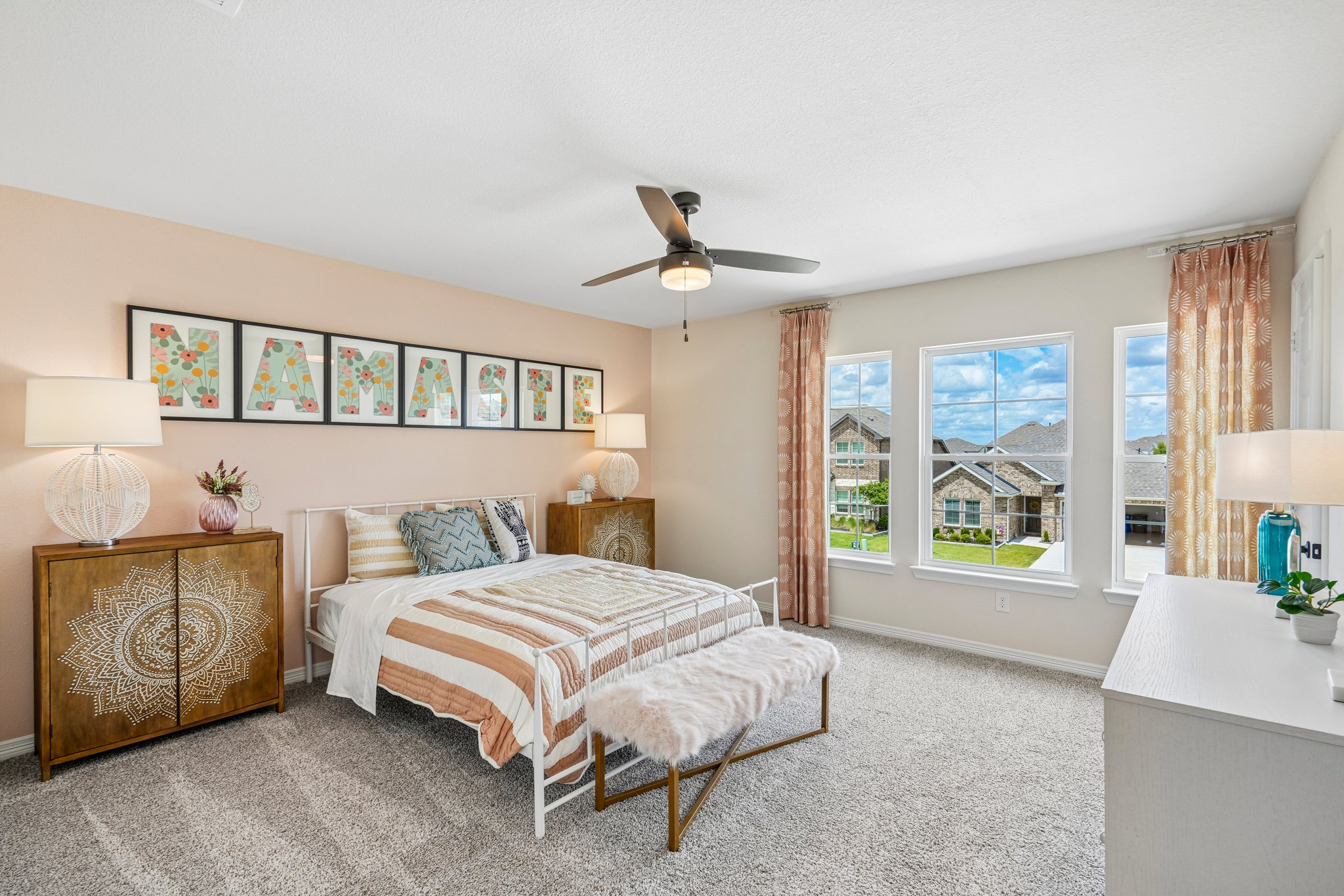 A bedroom with a bed and a fan.