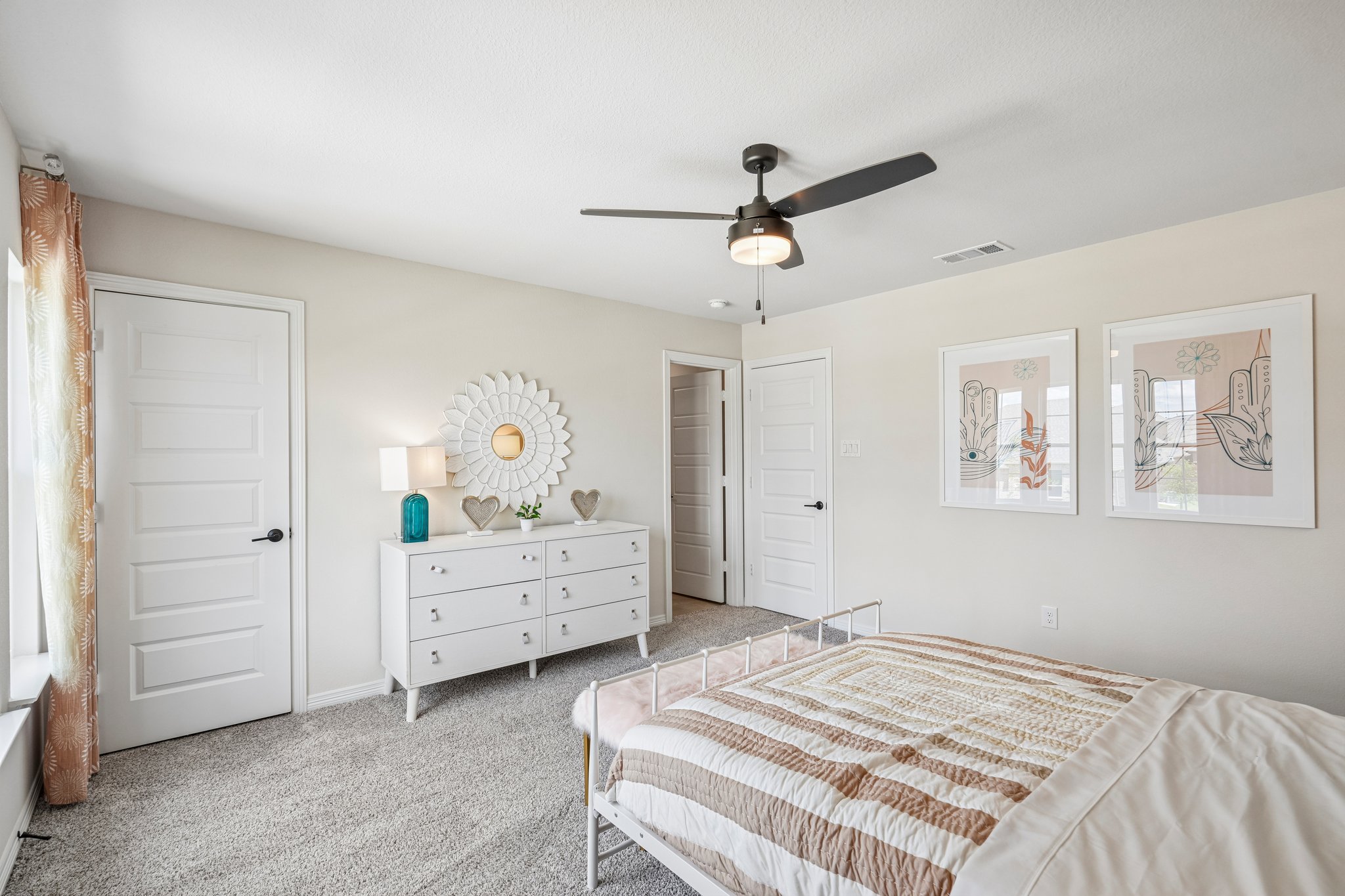 A bedroom with a bed and a fan.