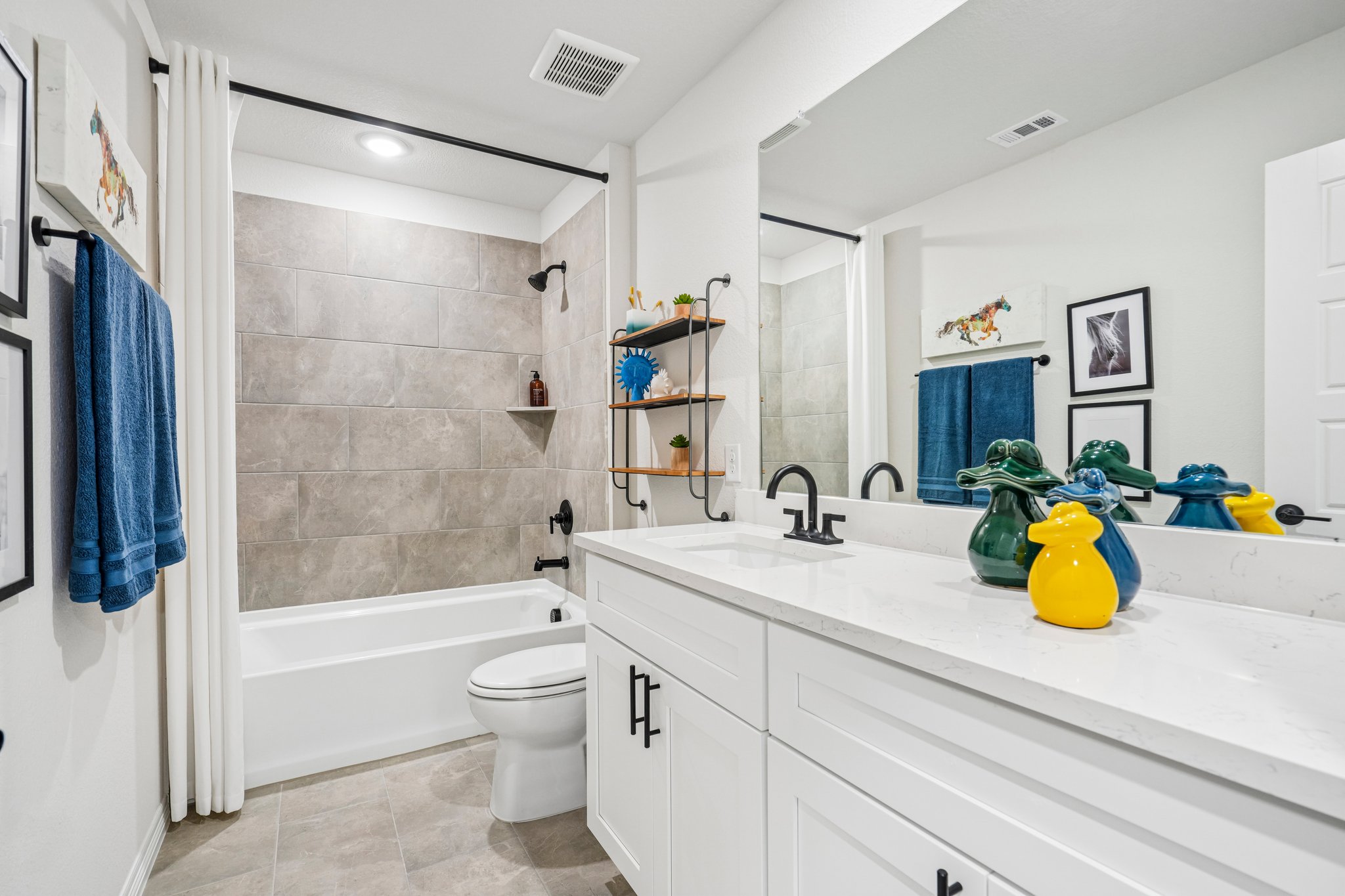 A bathroom with a tub sink and toilet.