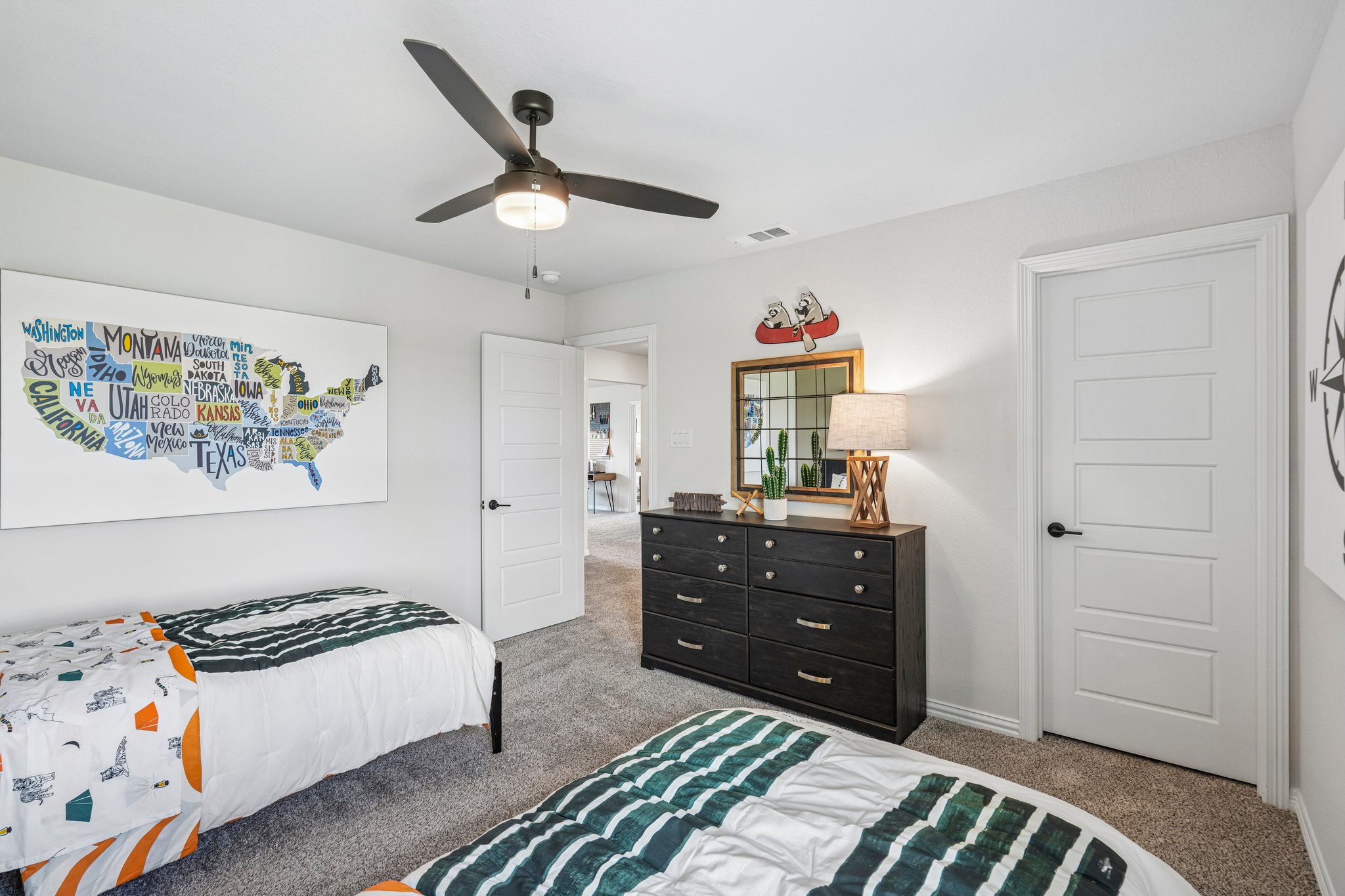 A bedroom with a fan and a bed.