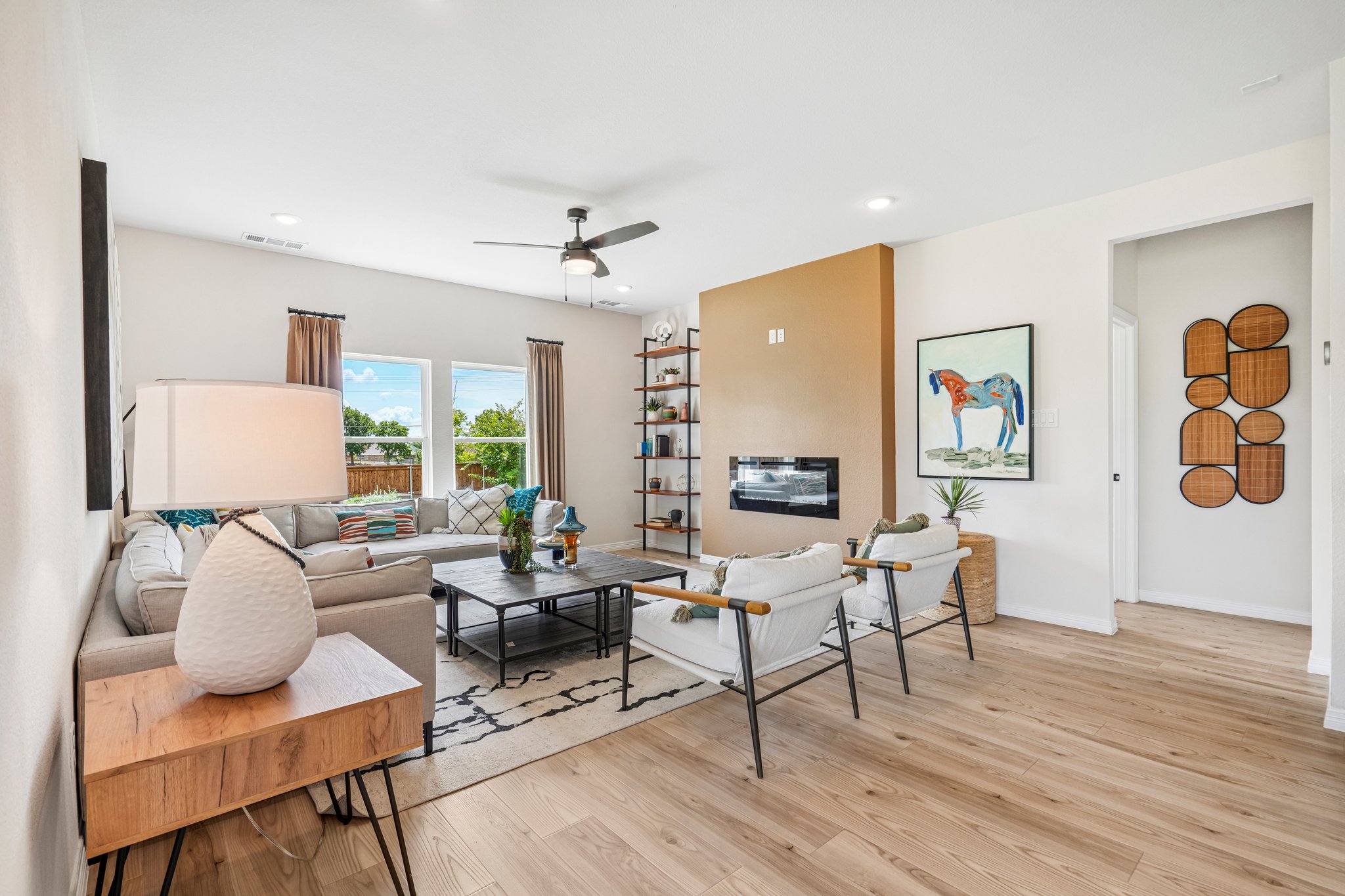 A living room with a large bookcase and a table.