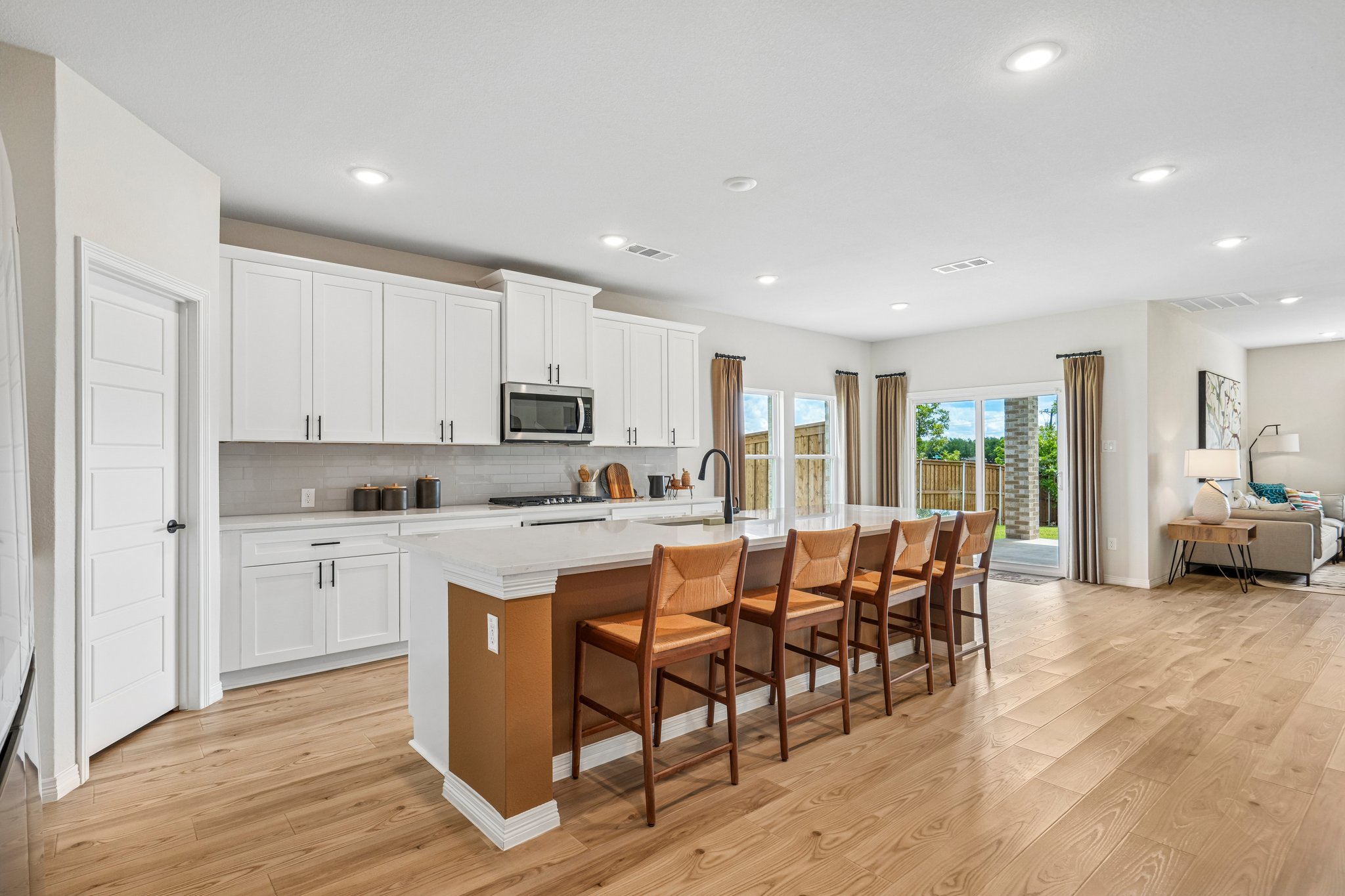 A kitchen with white cabinets.