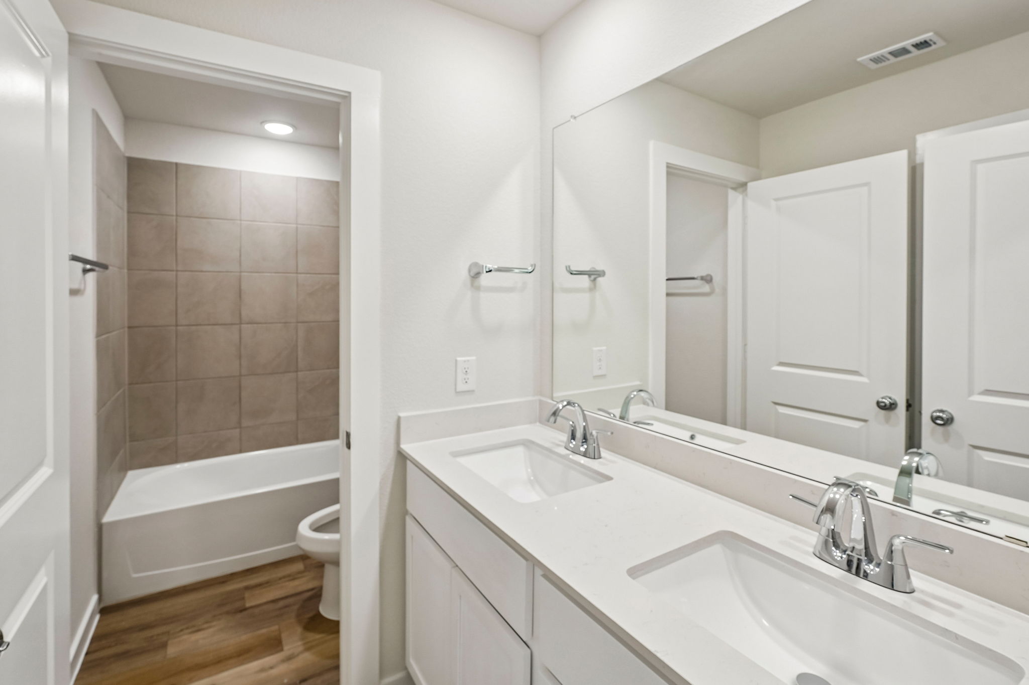 A bathroom with a tub sink and toilet.