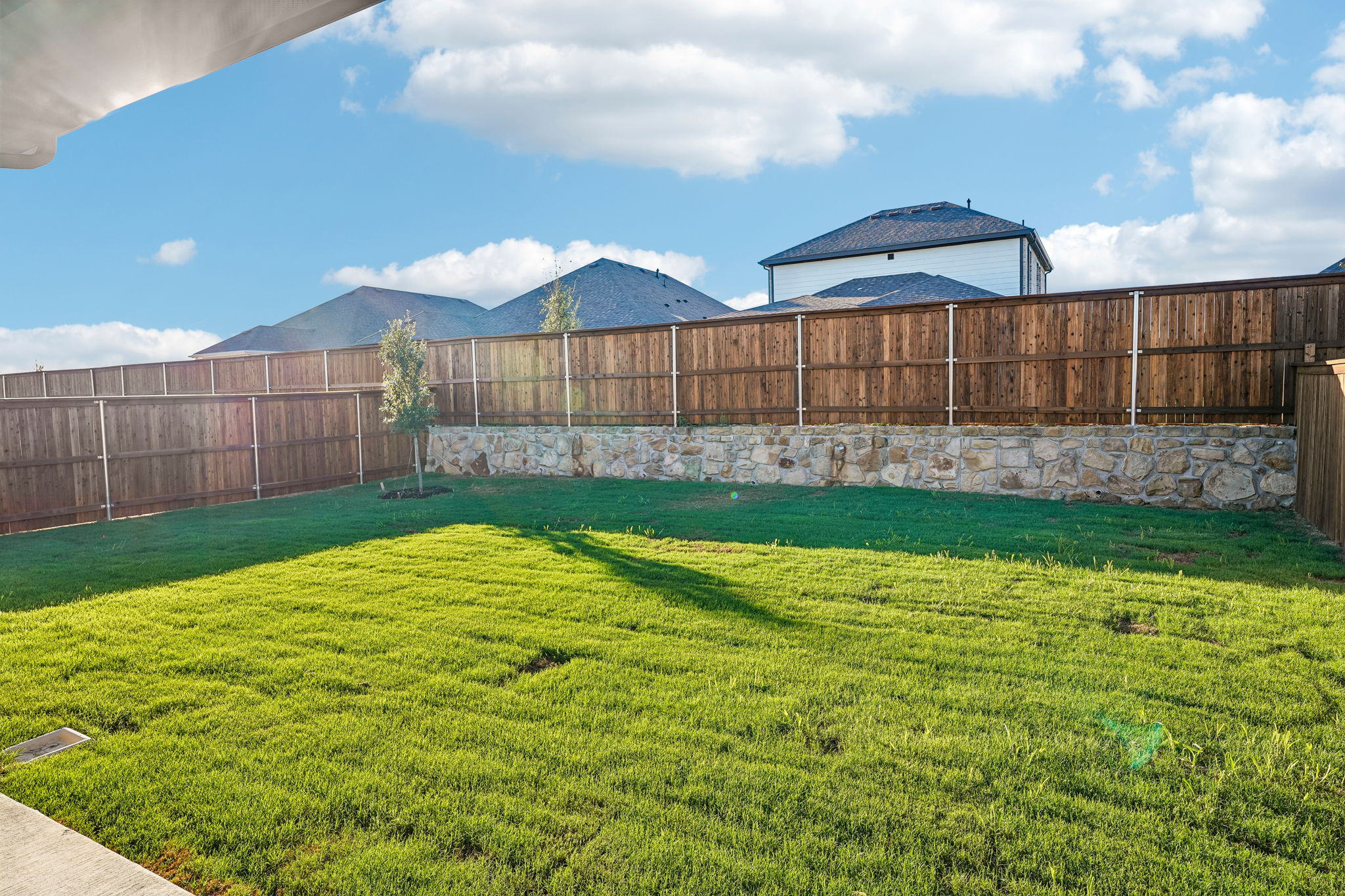 A fenced in yard with a building in the background.