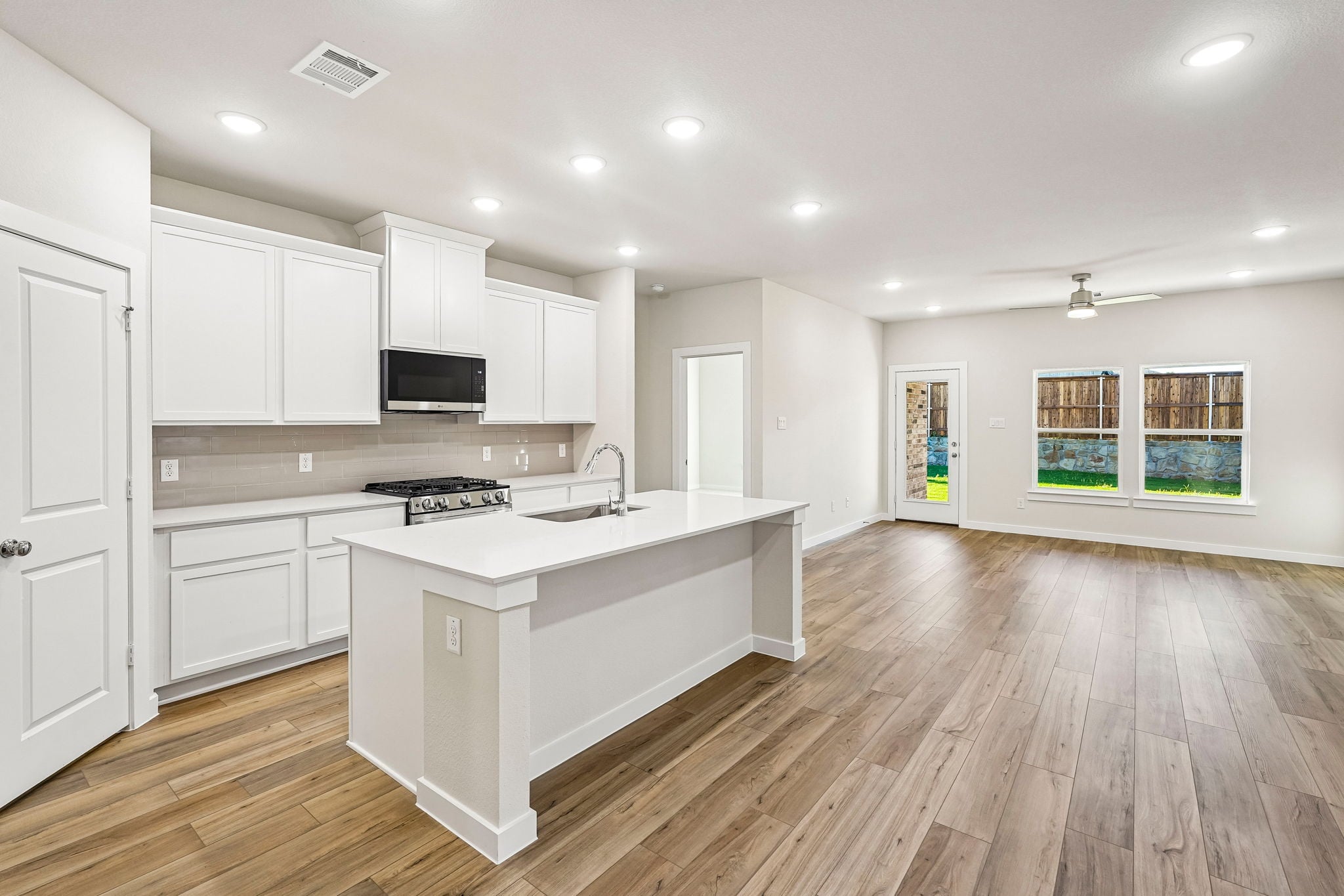 A kitchen with white cabinets.