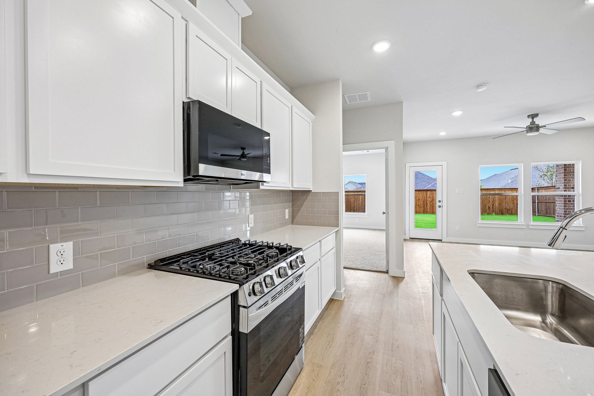 A kitchen with white cabinets.