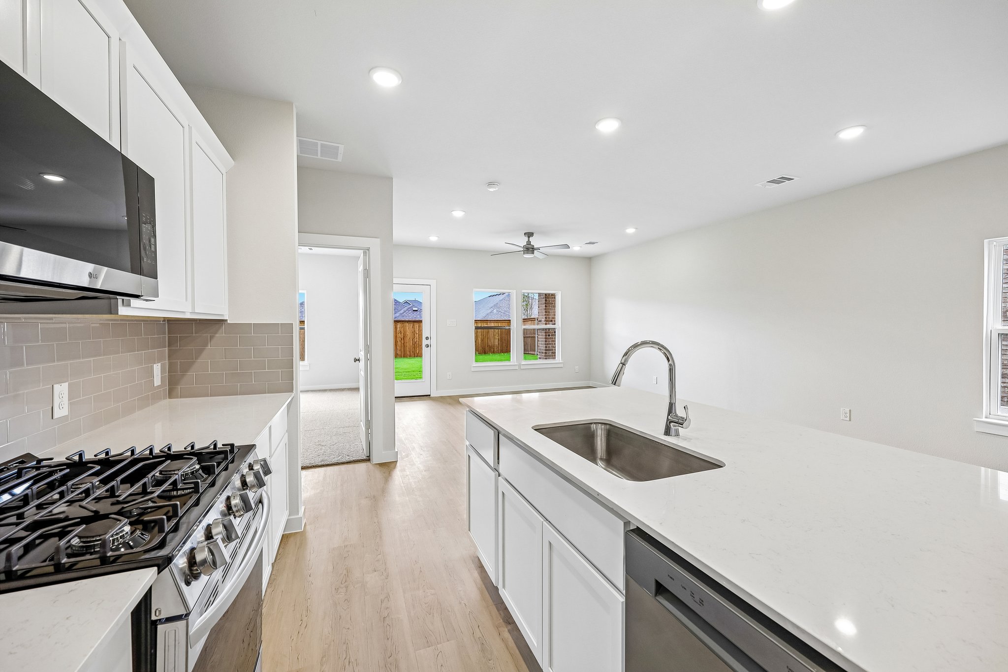A kitchen with white cabinets.