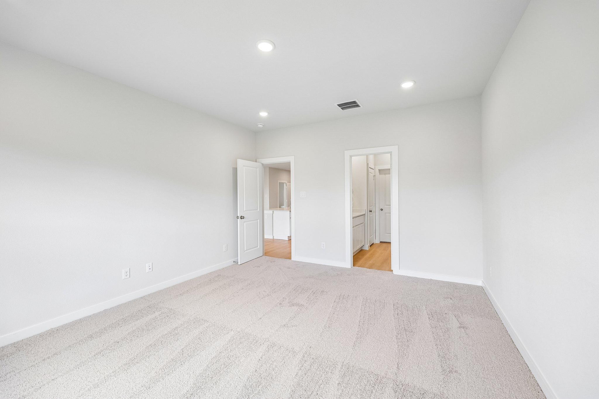 A hallway with white walls.