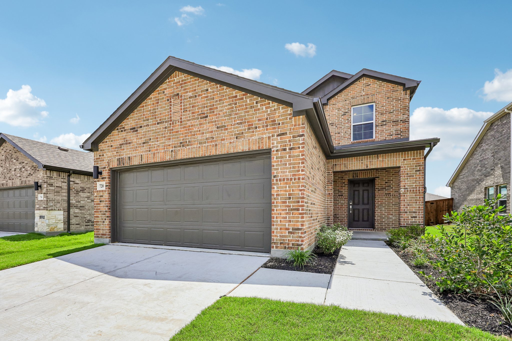 A brick house with a garage.