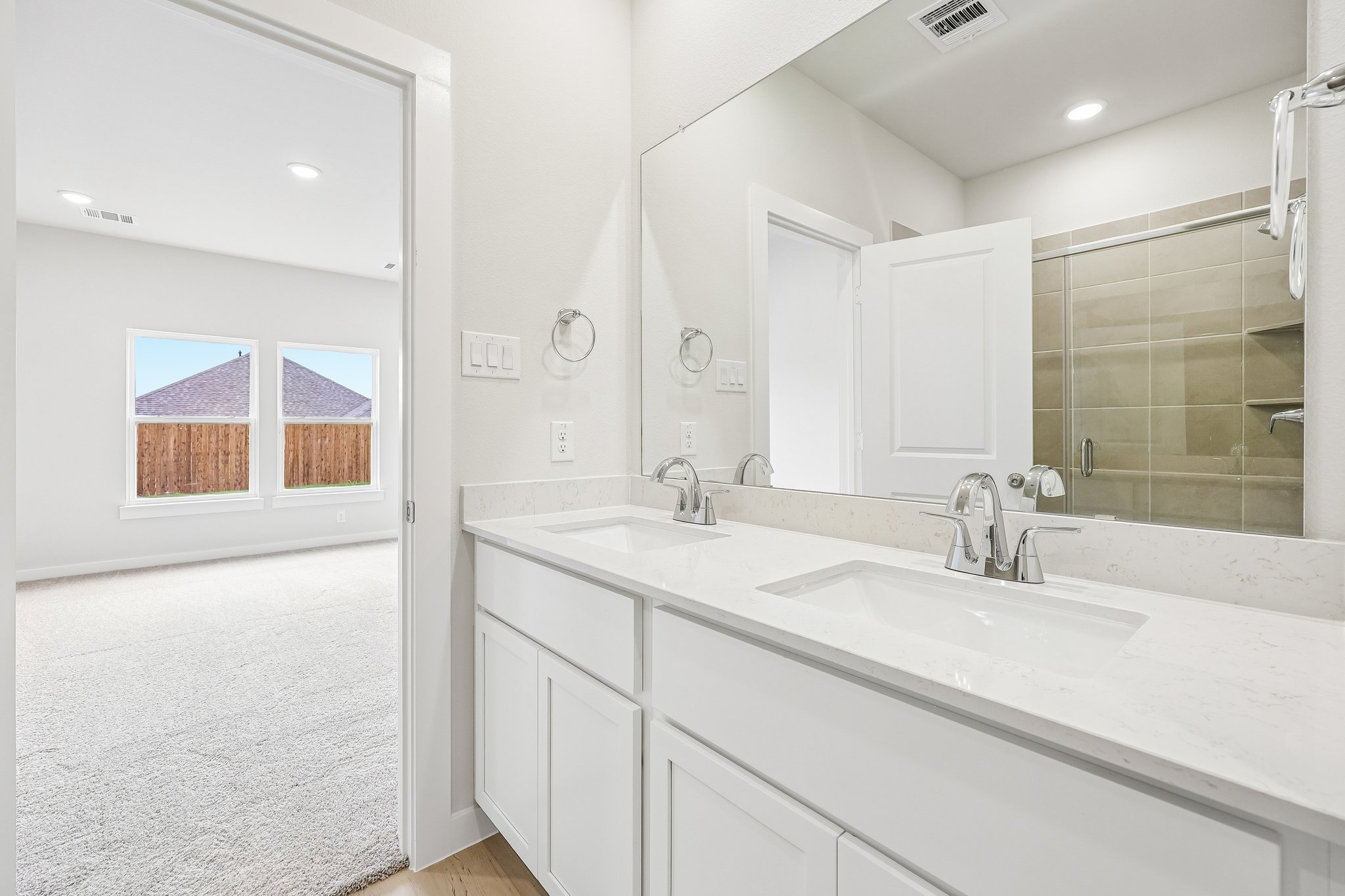 A bathroom with a large mirror.