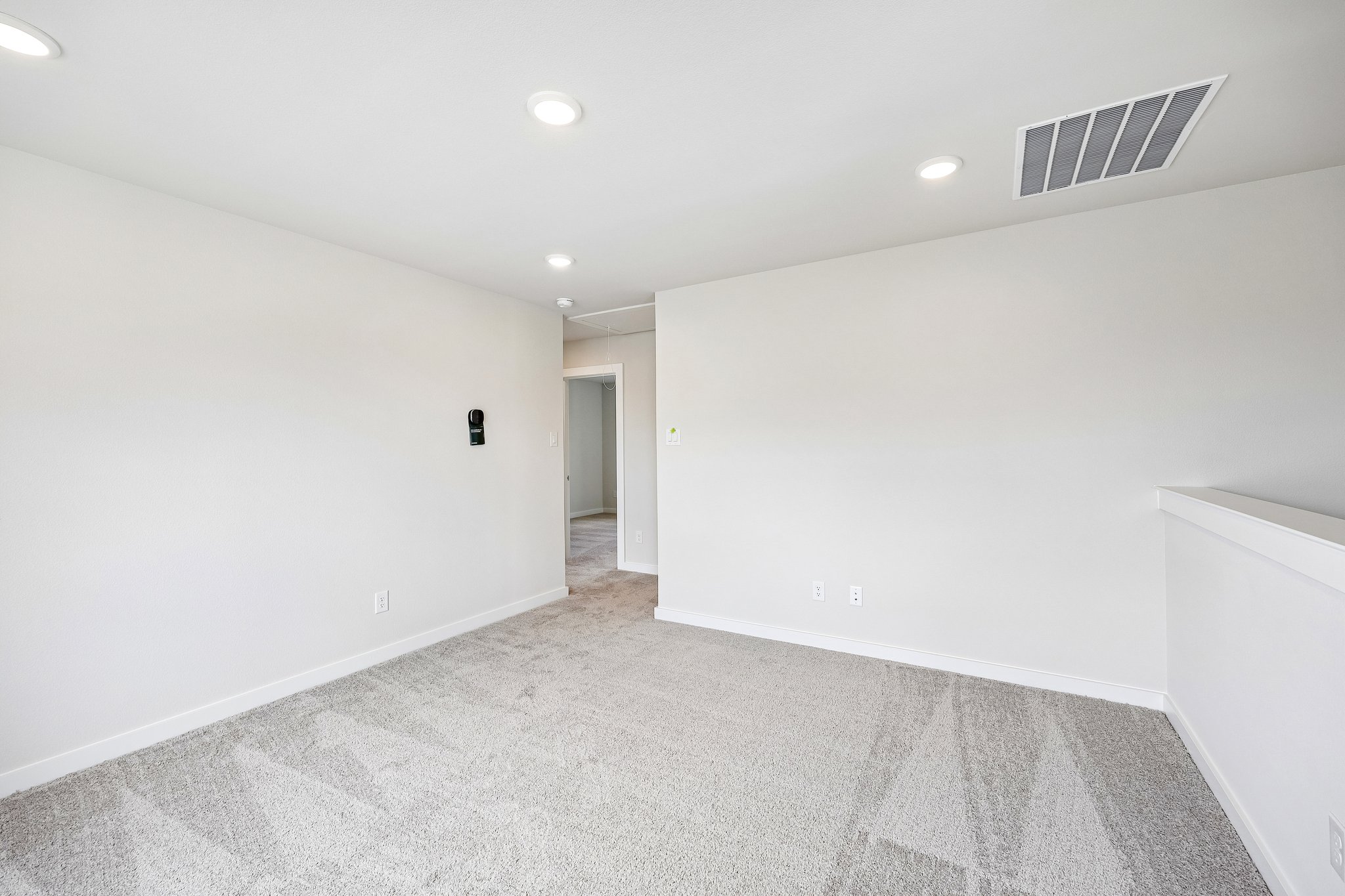 A hallway with white walls.