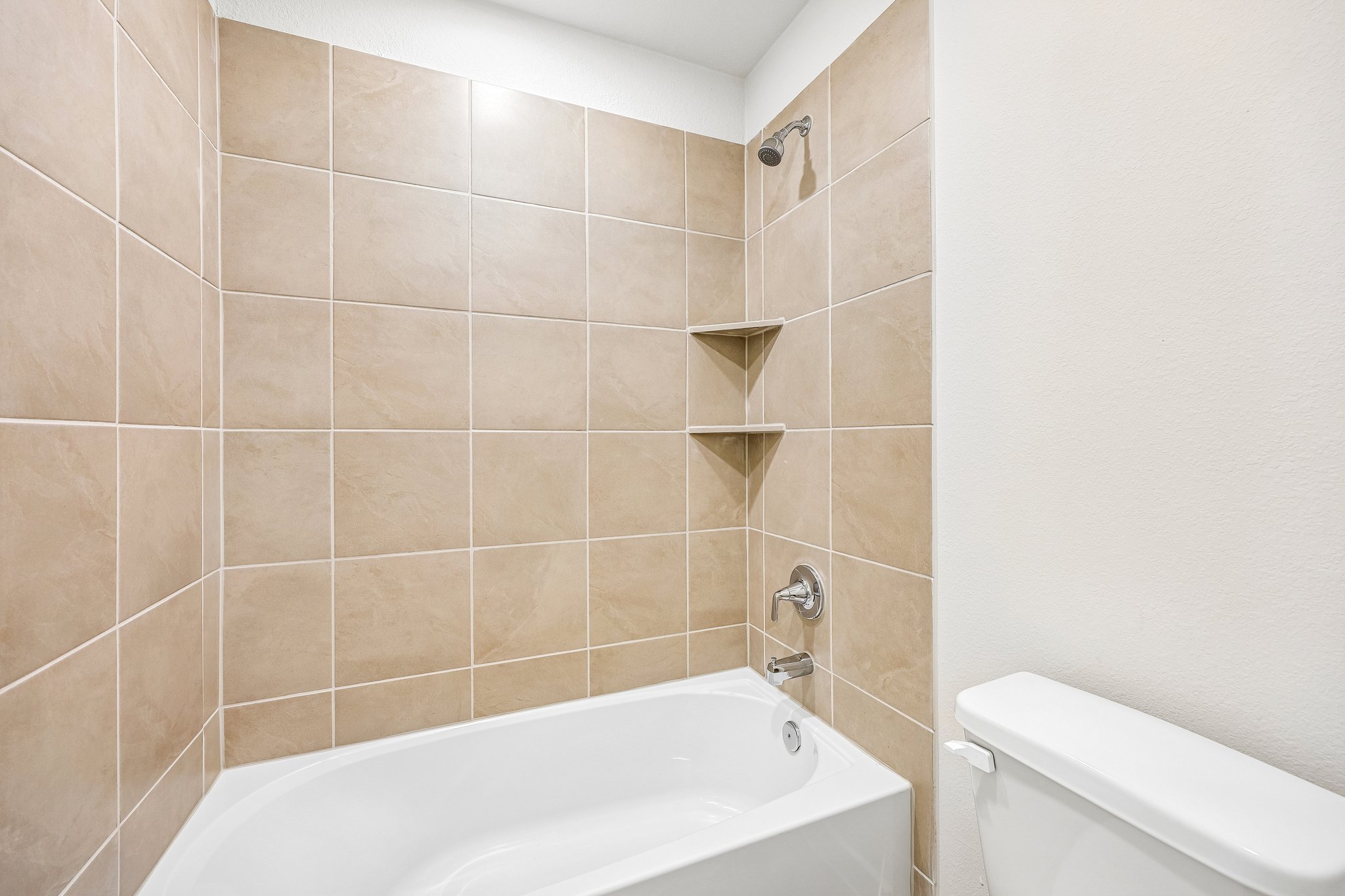 A bathroom with a bathtub and toilet.