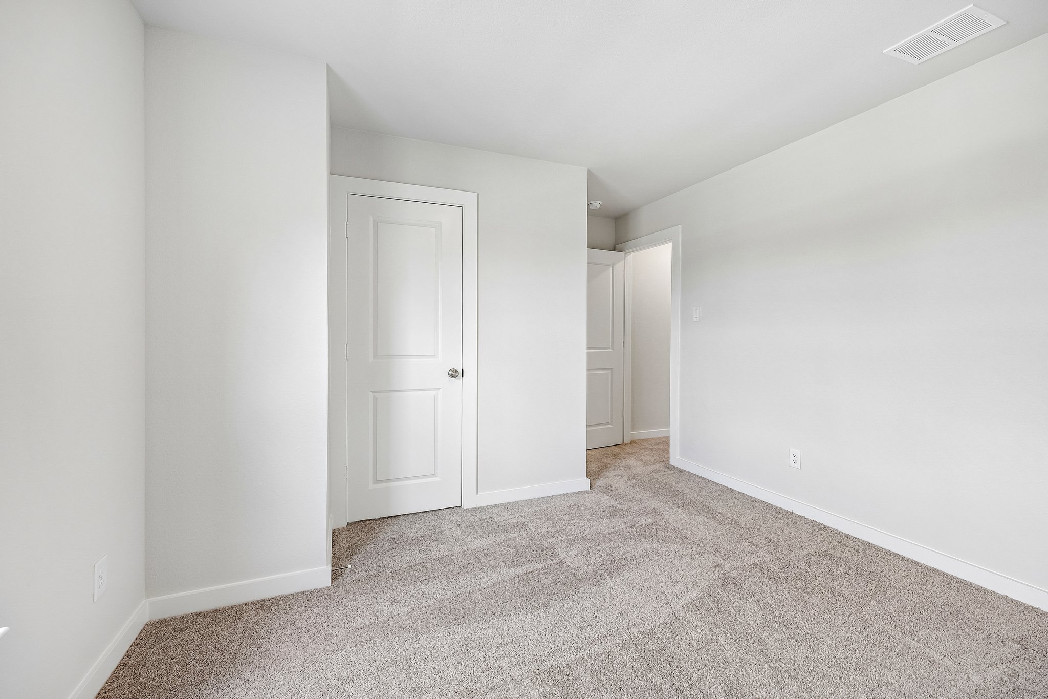 A hallway with white doors.