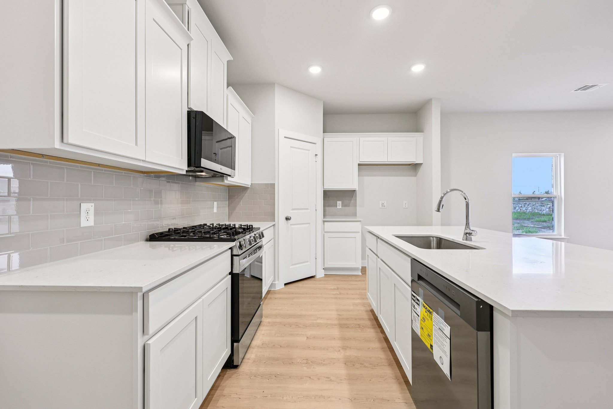 A kitchen with white cabinets.