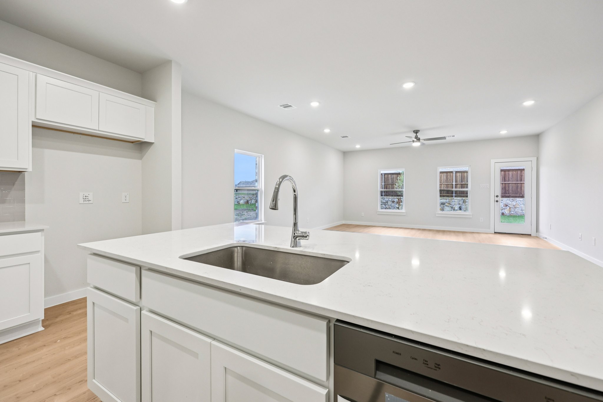 A kitchen with white cabinets.