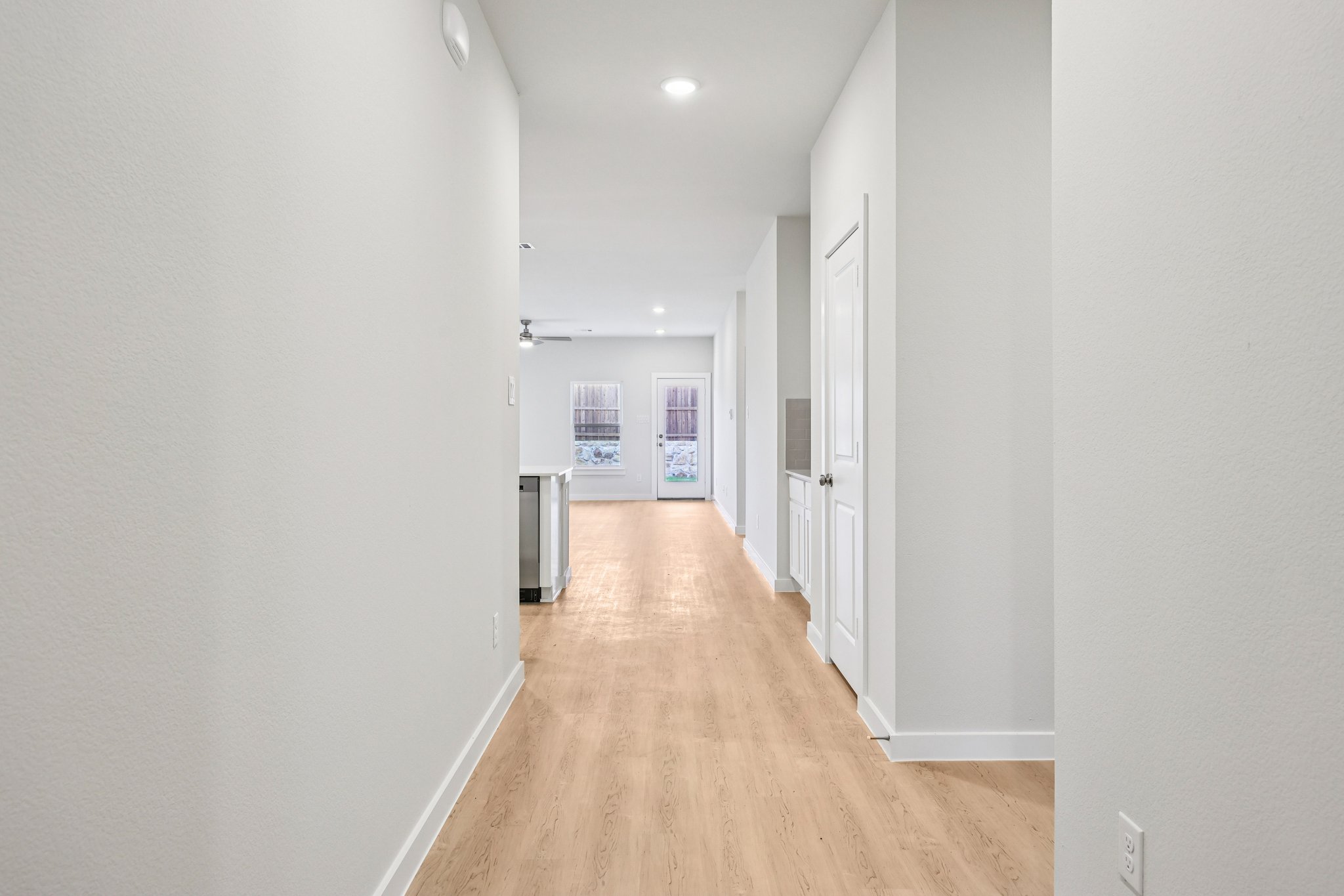 A long hallway with white walls.