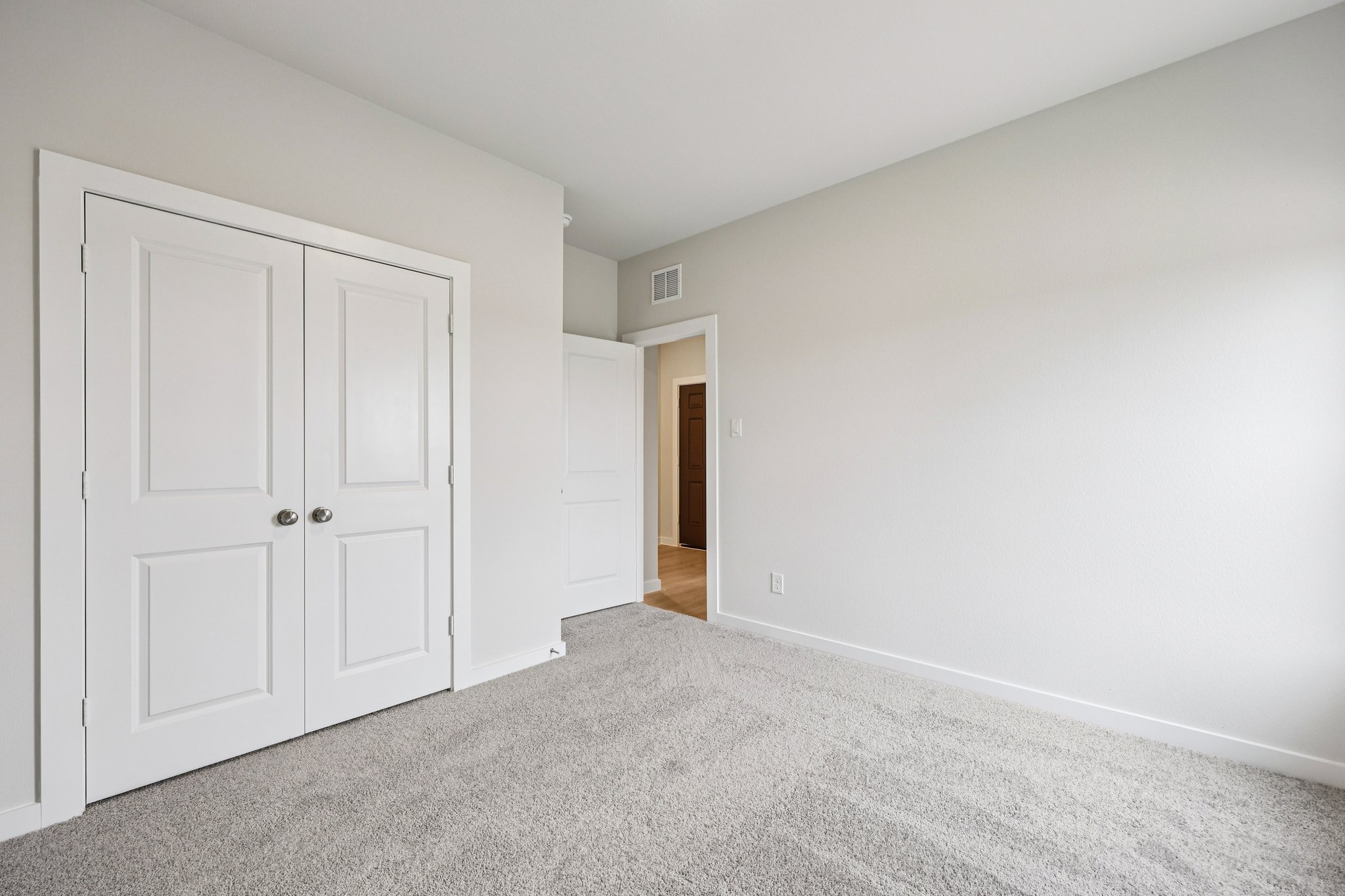 A hallway with white doors.