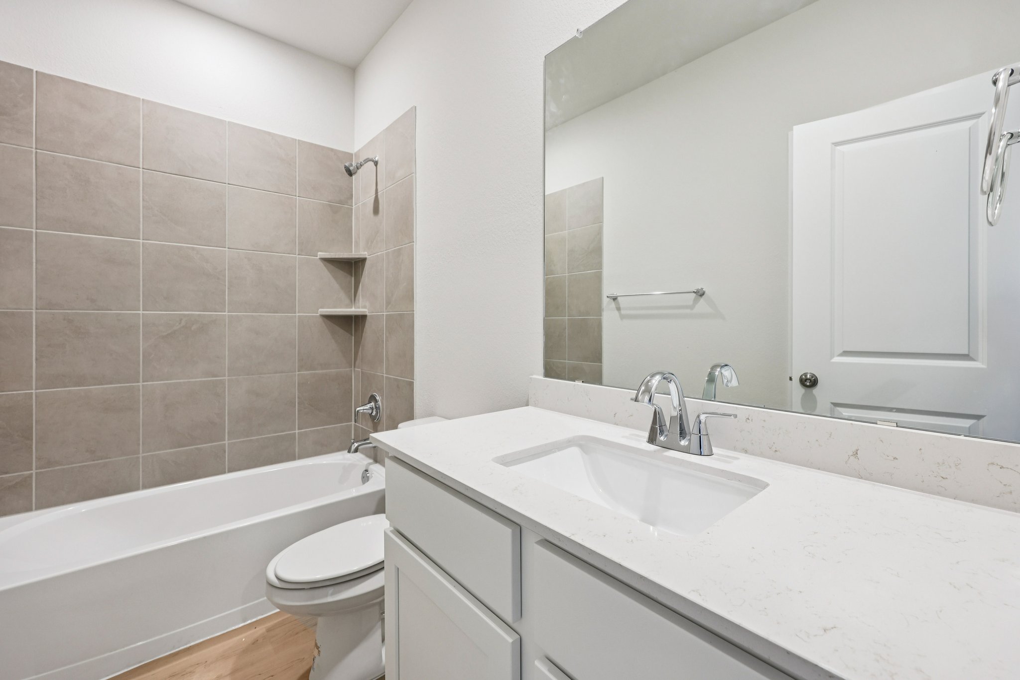 A bathroom with a sink toilet and bathtub.