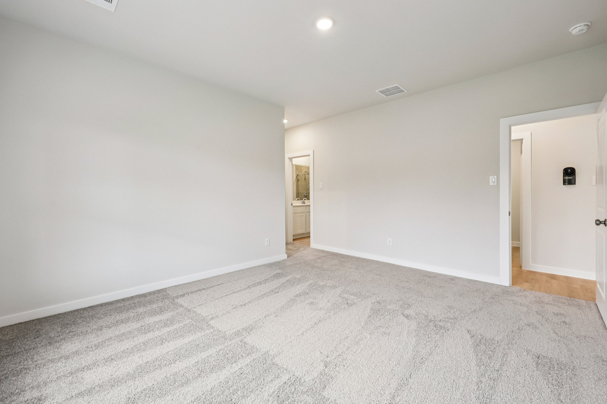 A hallway with white walls.