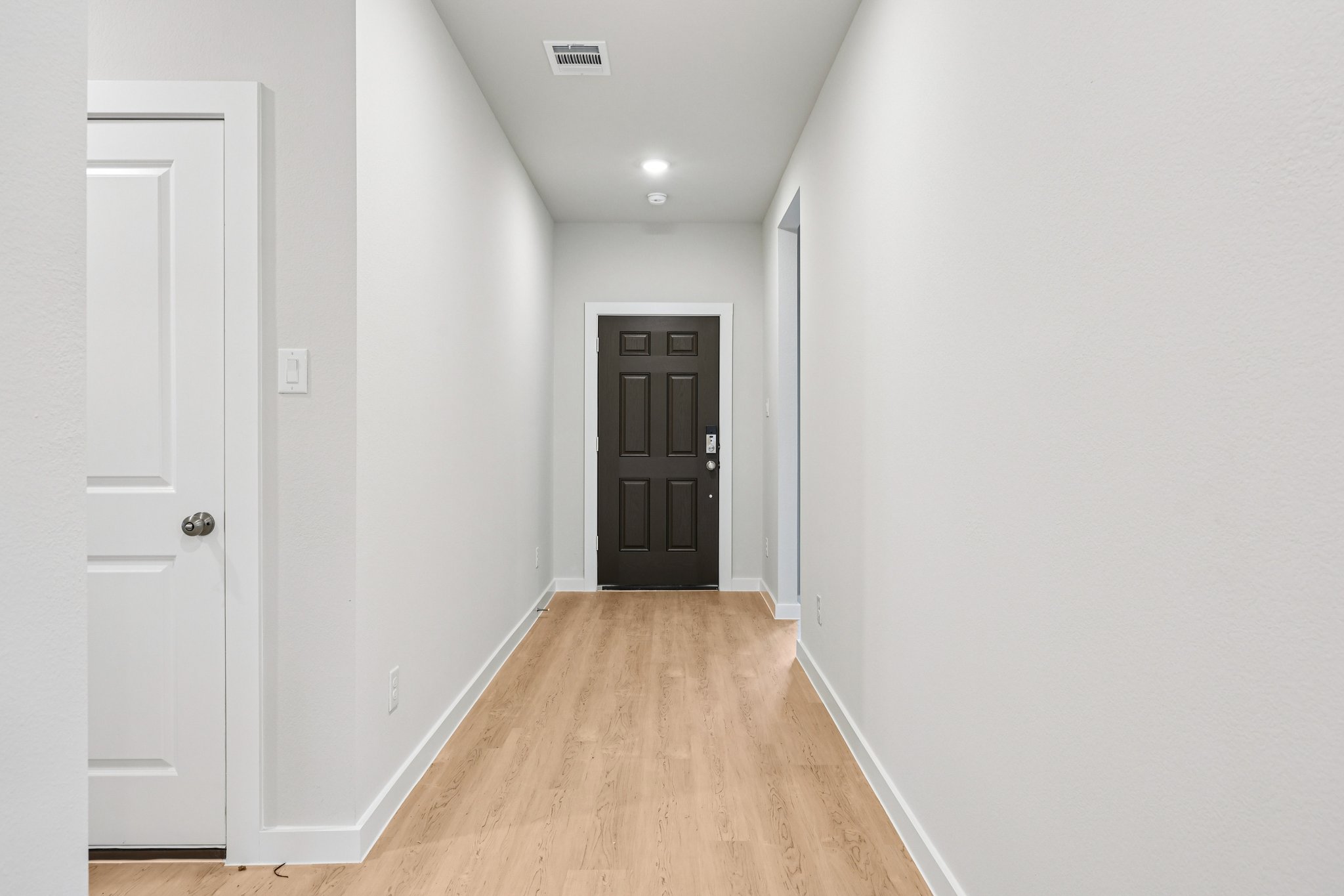A hallway with white walls.