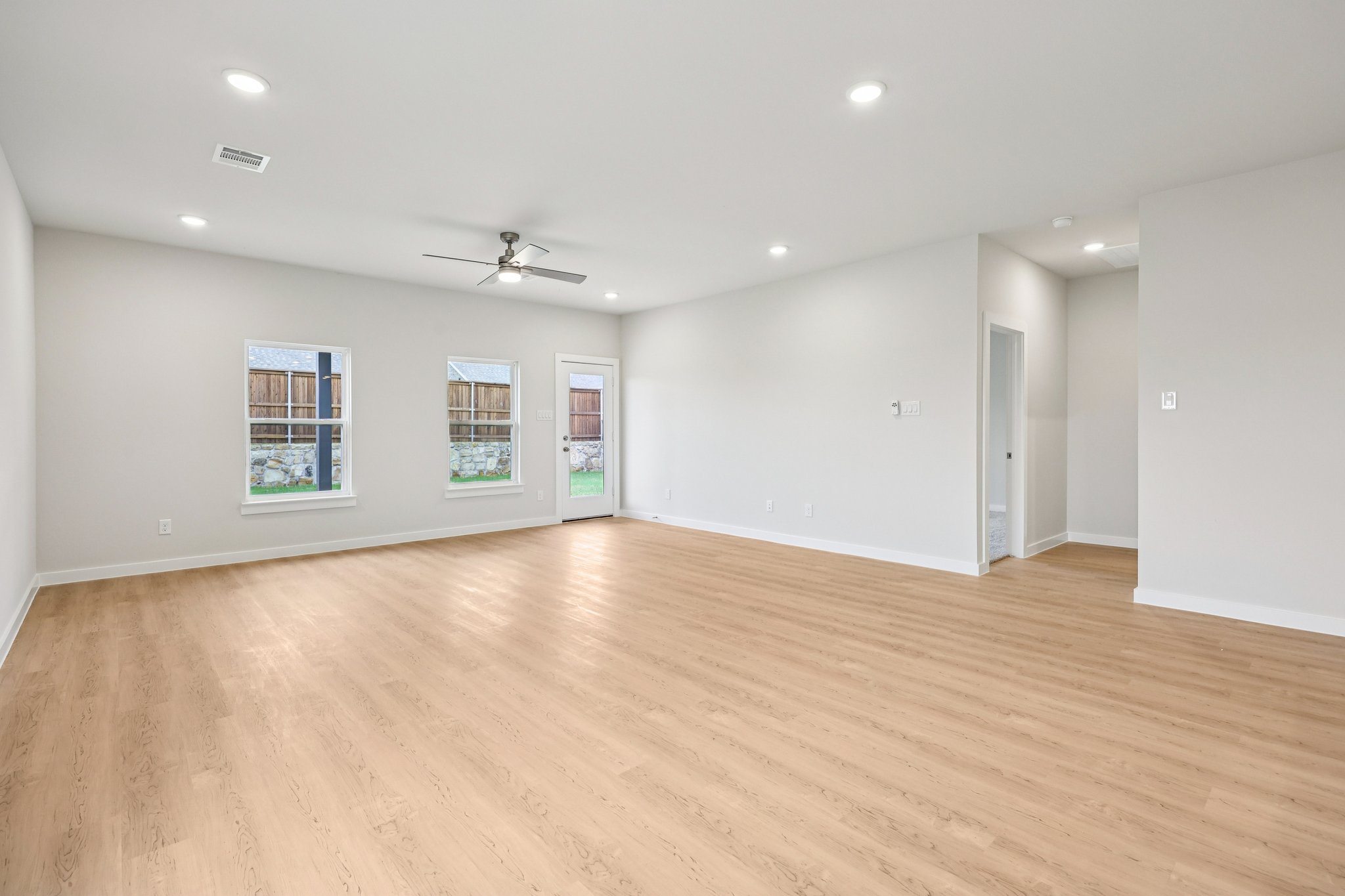 A room with a wood floor and a wood floor.