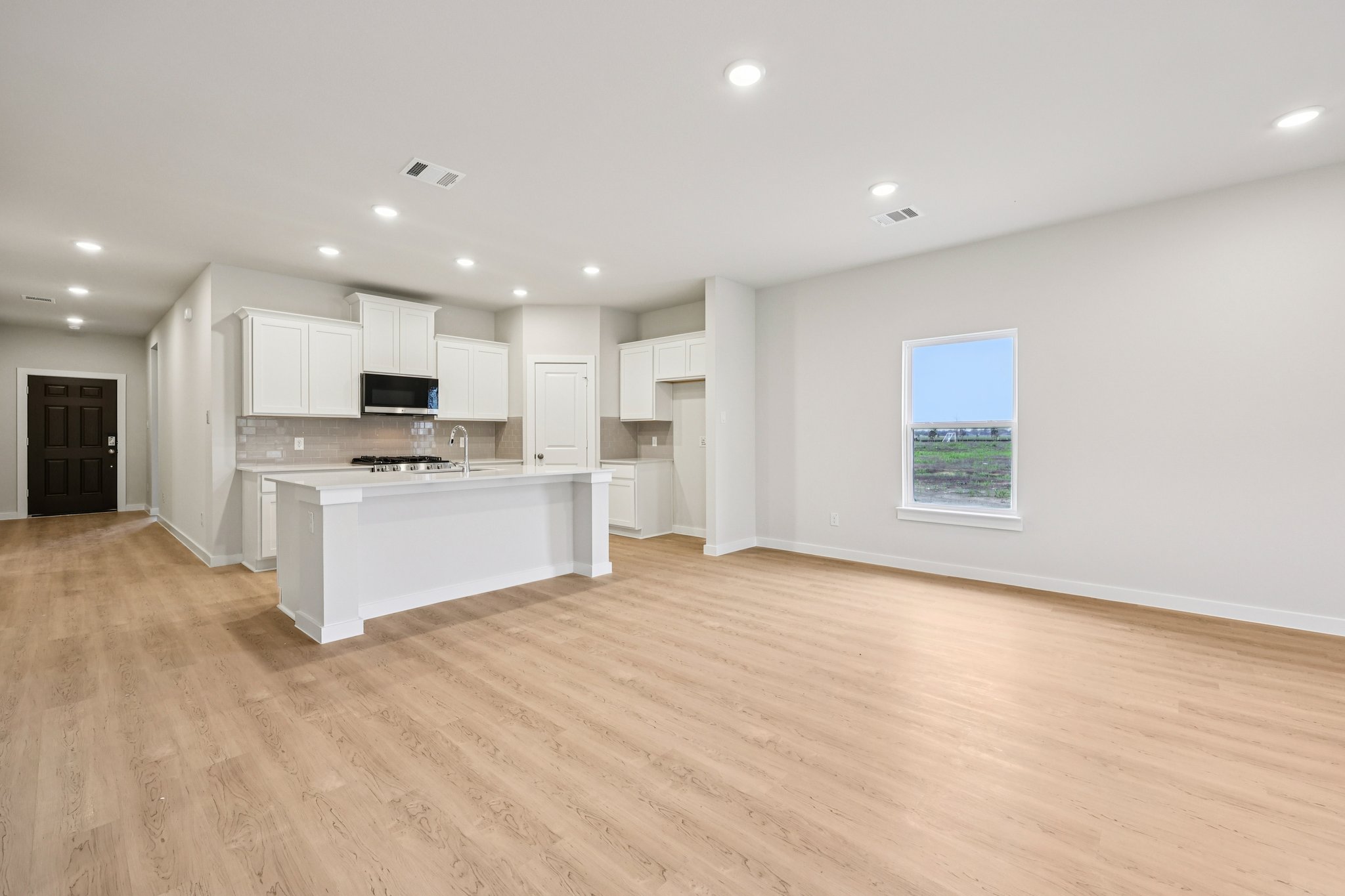 A large kitchen with white cabinets.