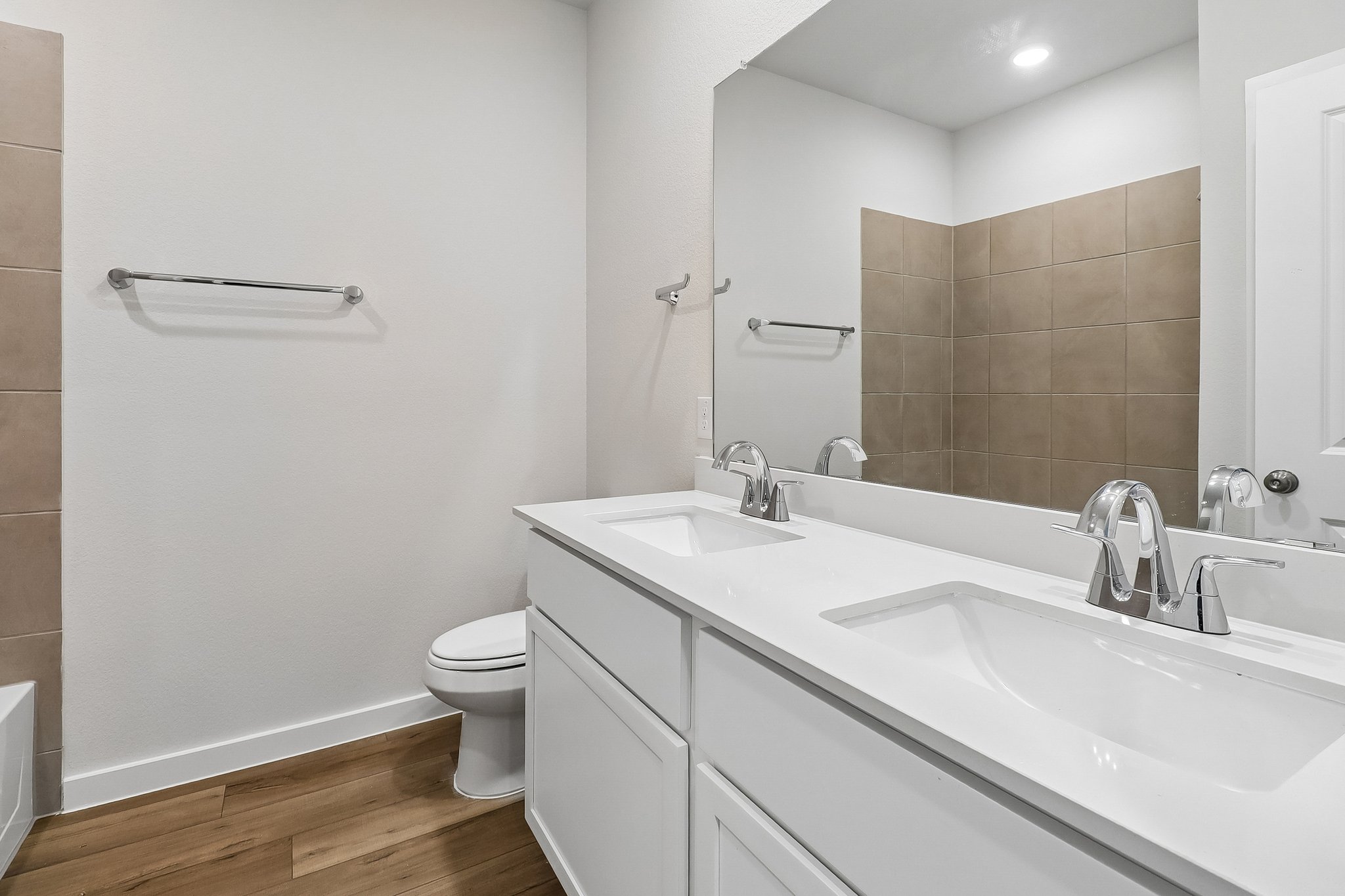 A bathroom with a tub sink and toilet.