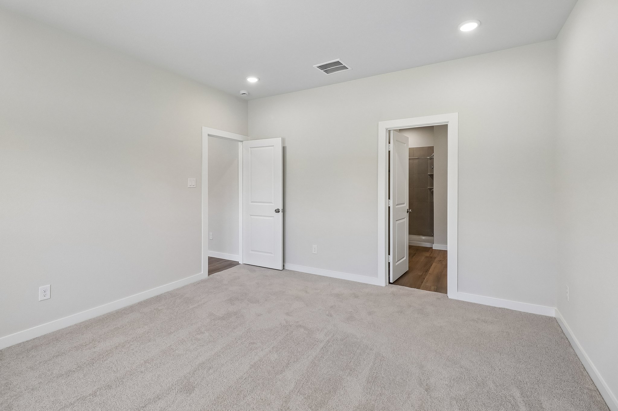 A hallway with white doors.