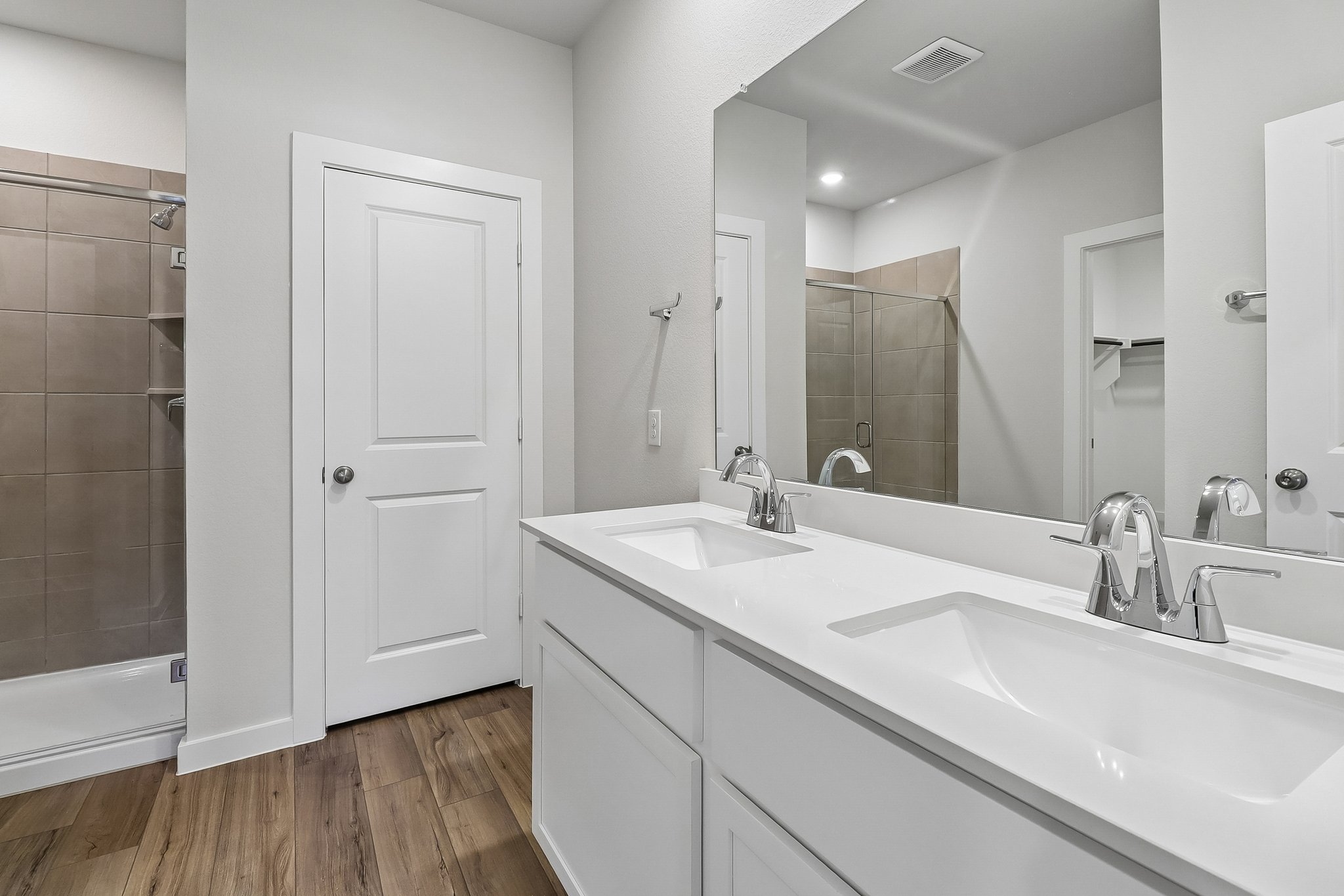A bathroom with a large mirror.