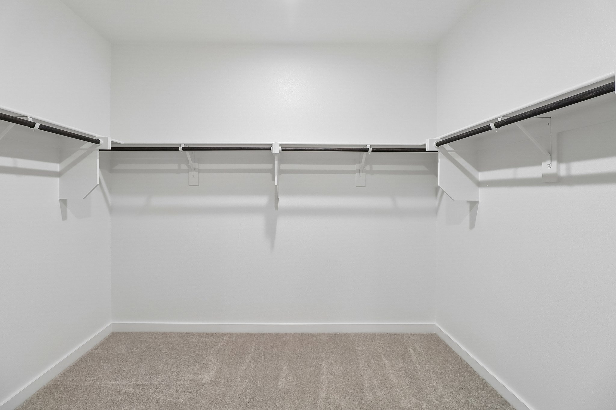 A white room with a carpet.