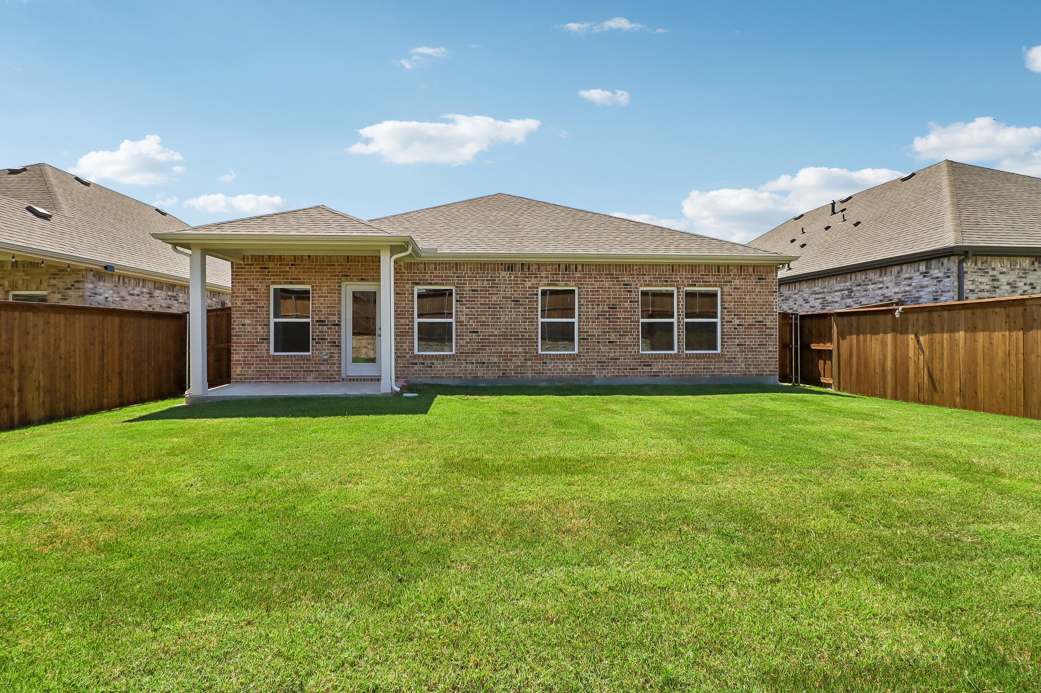 A house with a green lawn.