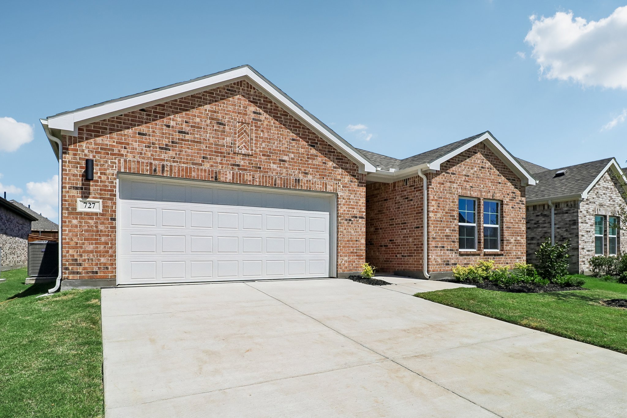 A brick building with a garage.