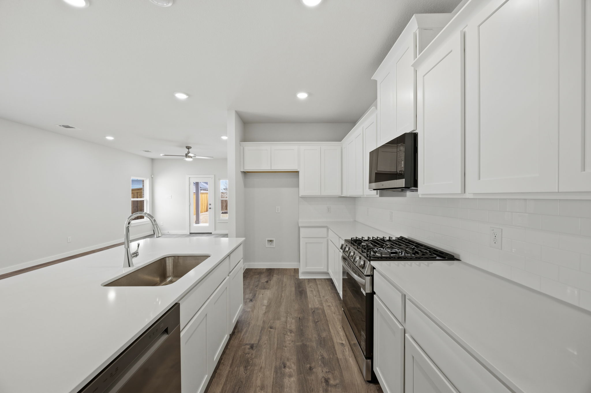 A kitchen with white cabinets.