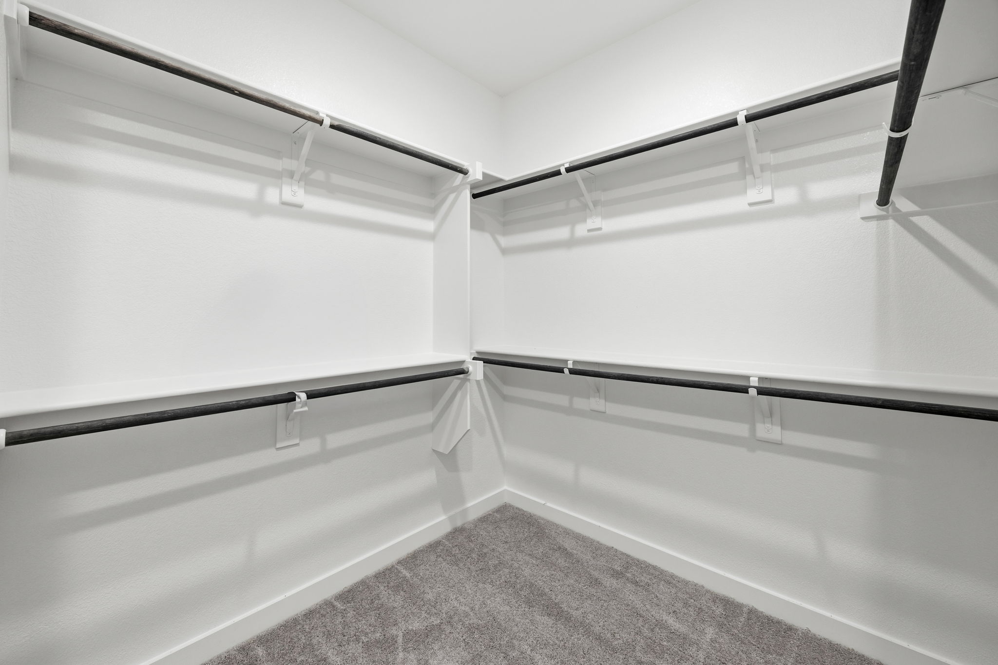 A white wall with a metal railing.