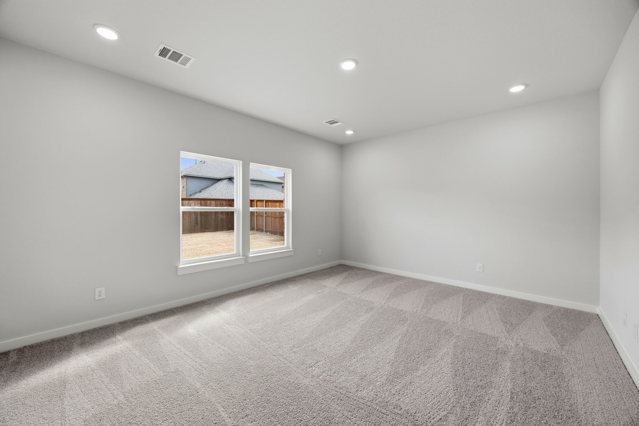 A room with a window and a carpet.