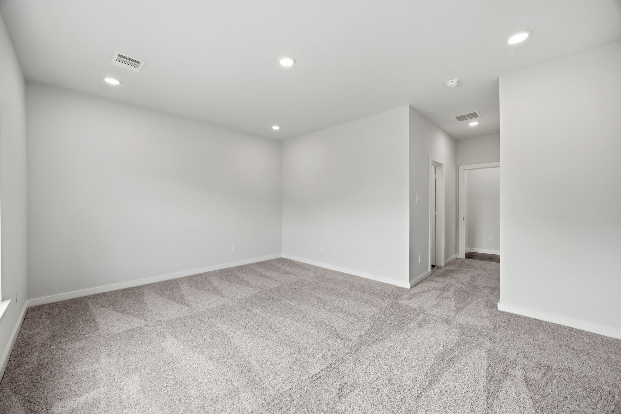 A long hallway with white walls.