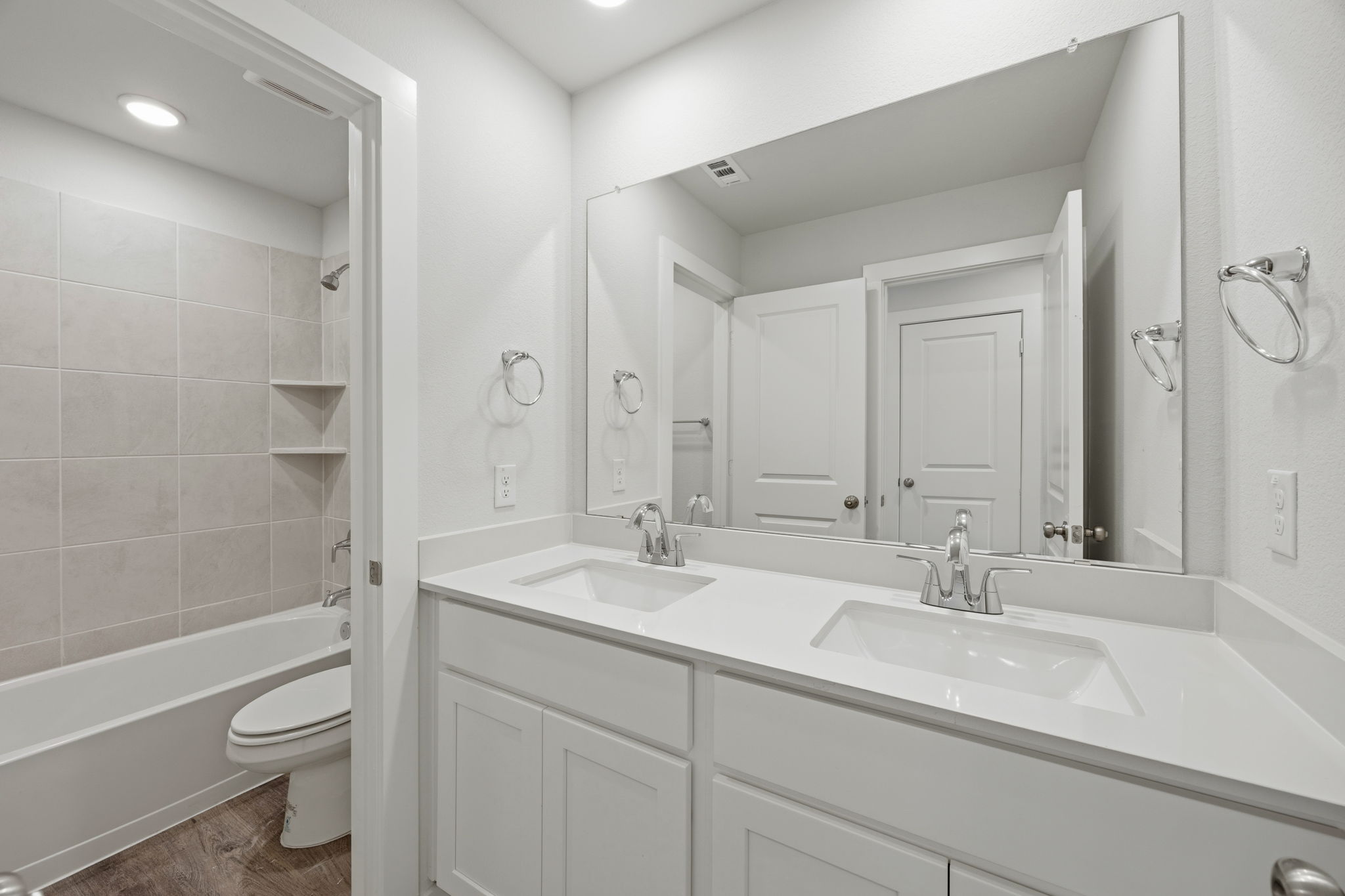 A bathroom with a tub sink and toilet.