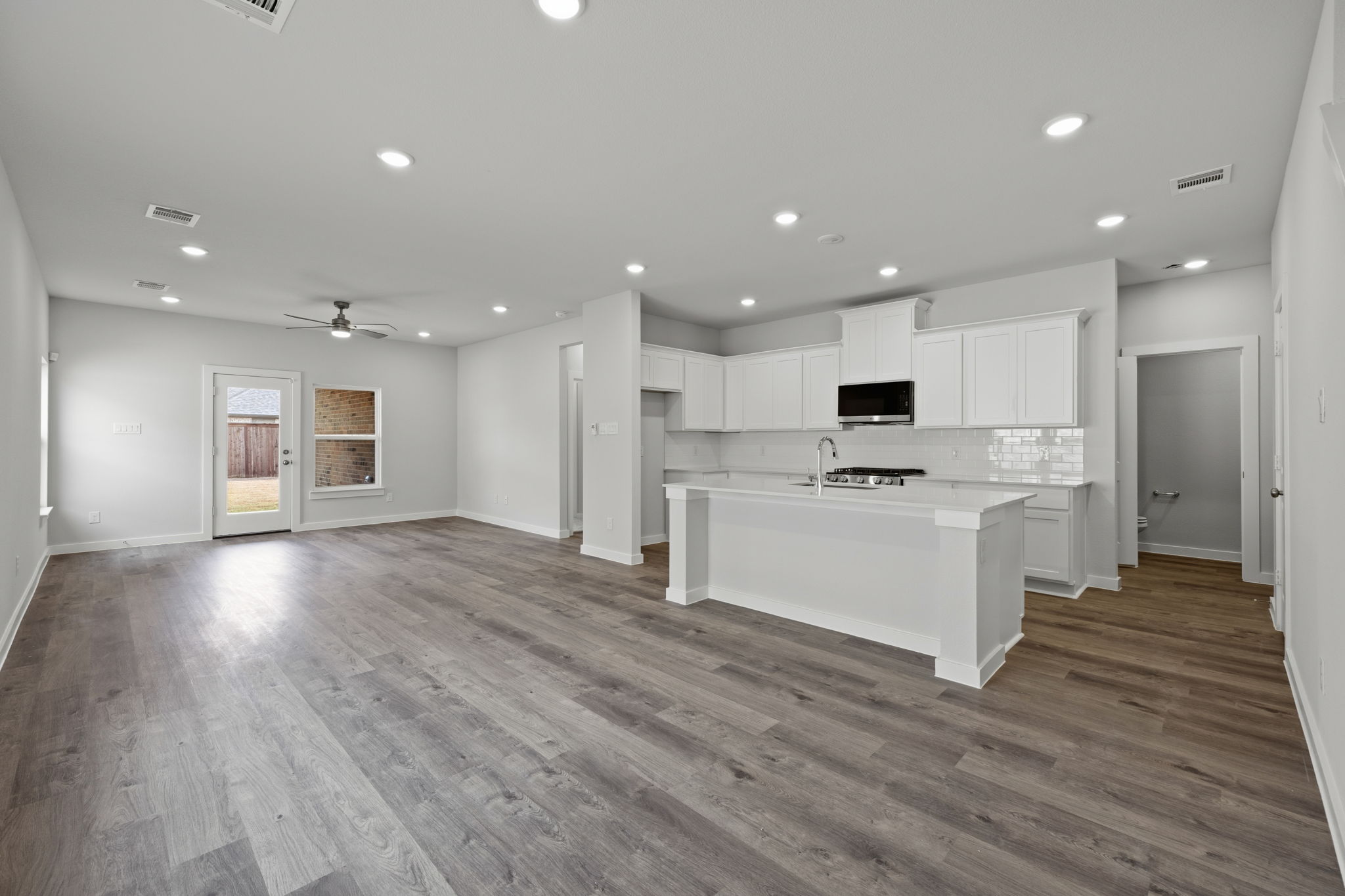 A large kitchen with white cabinets.