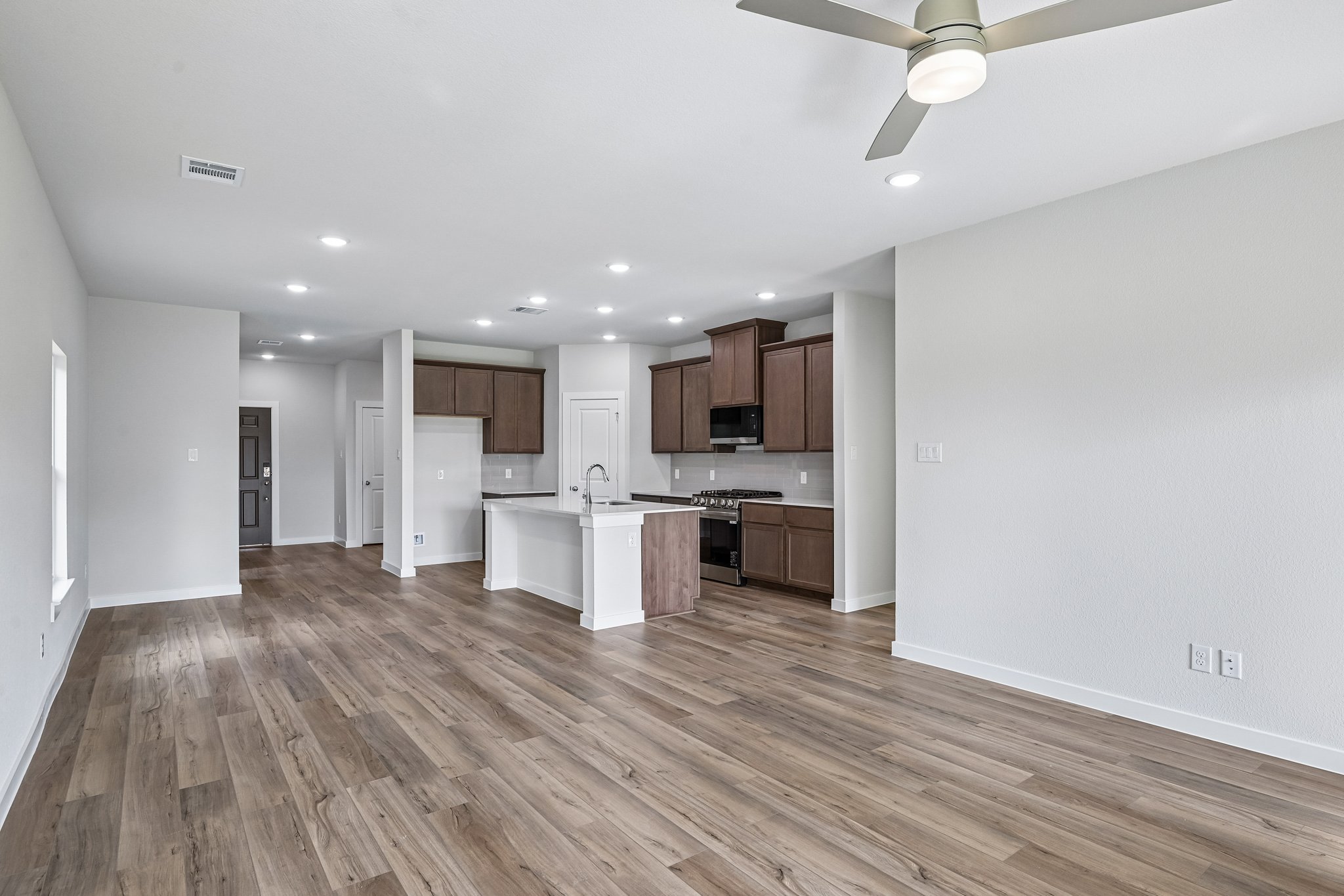 A large kitchen with wooden floors.