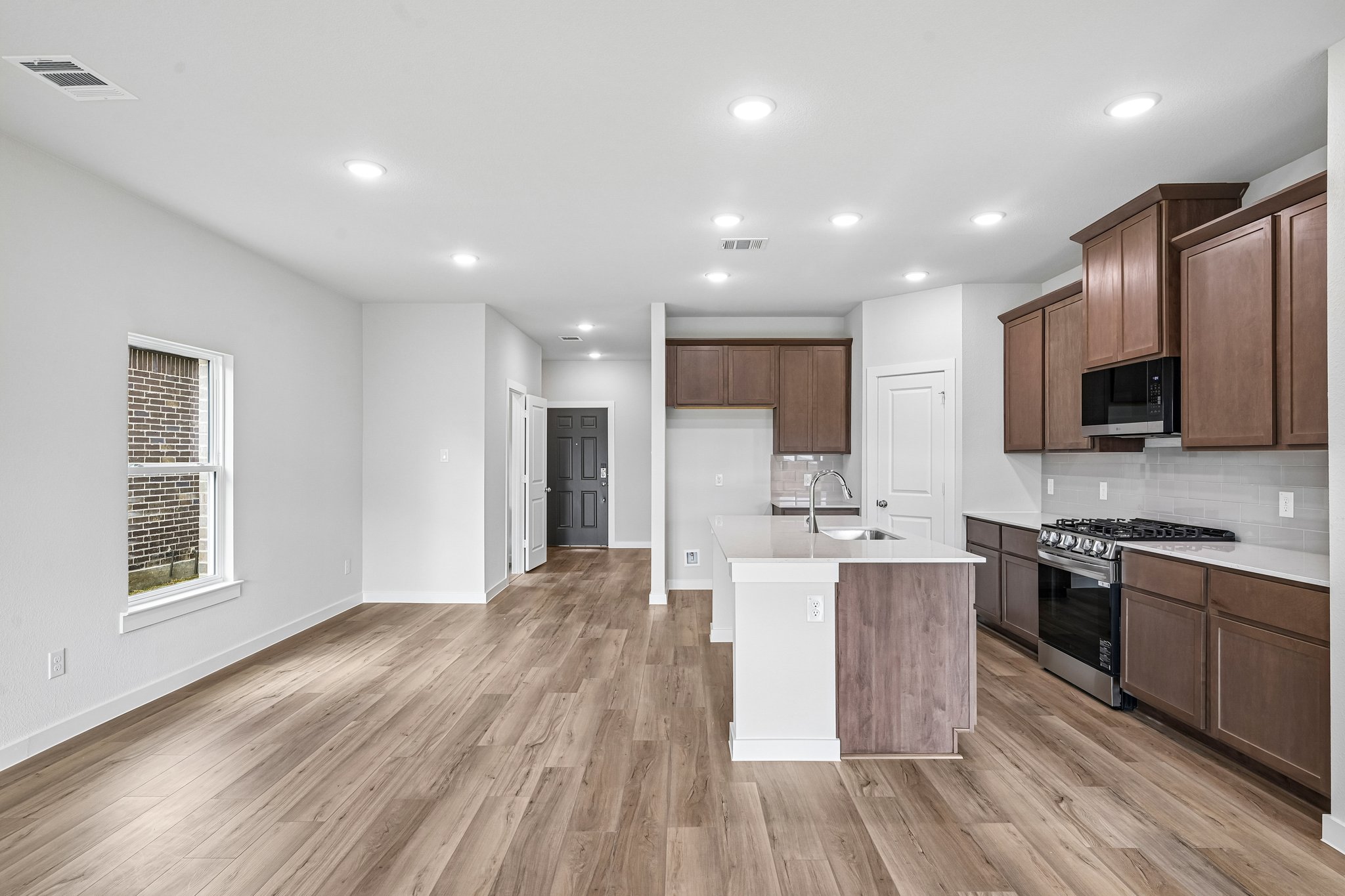 A kitchen with wooden cabinets.