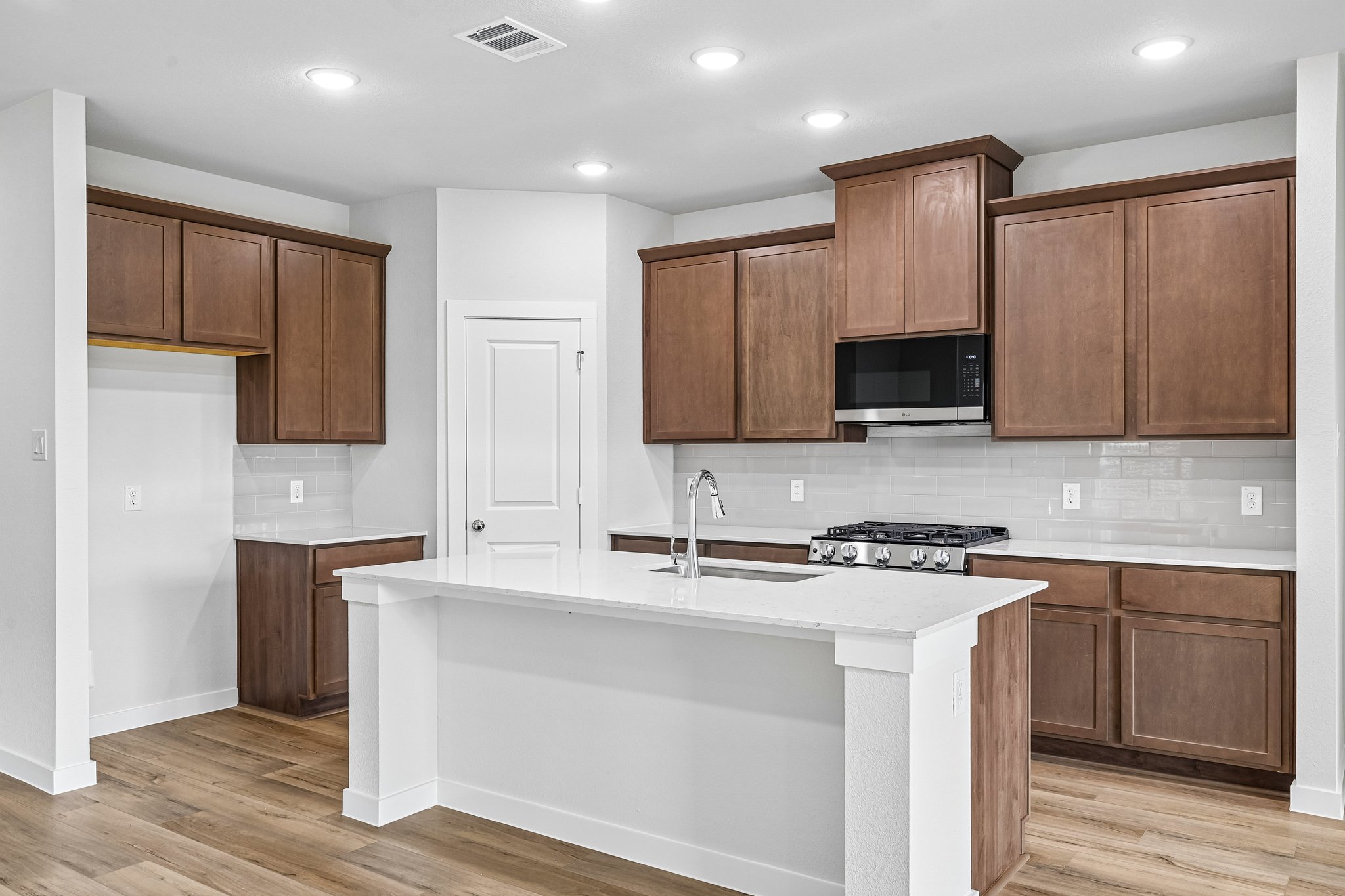 A kitchen with wooden cabinets.