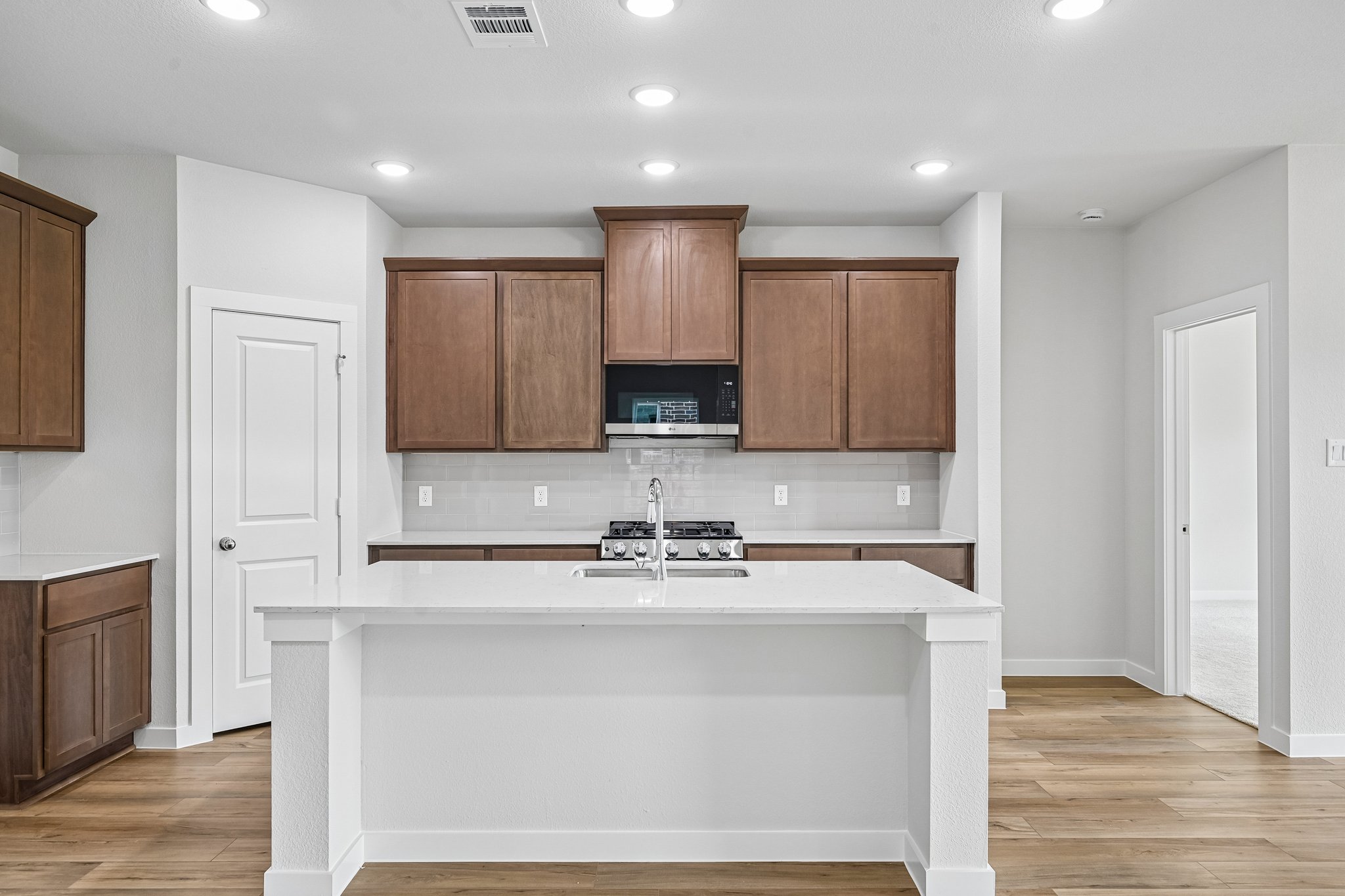 A kitchen with wooden cabinets.